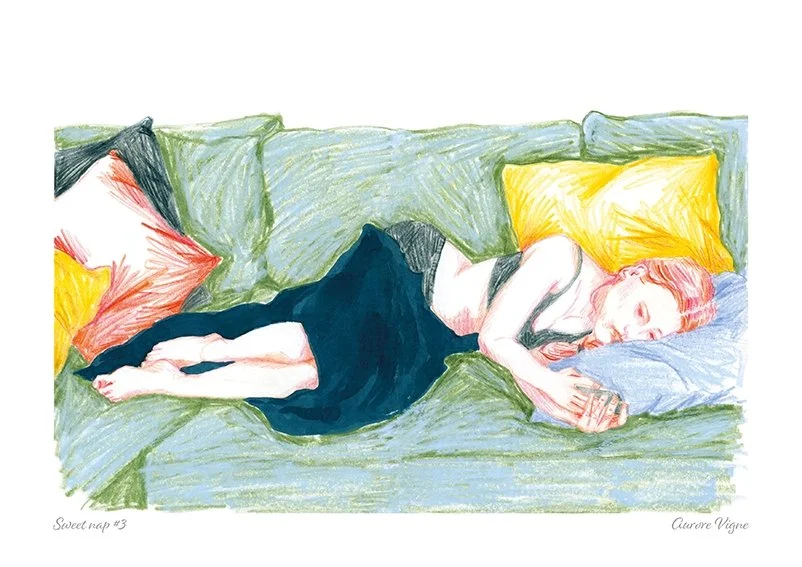A young girl is having a sweet nap on a colored sofa.