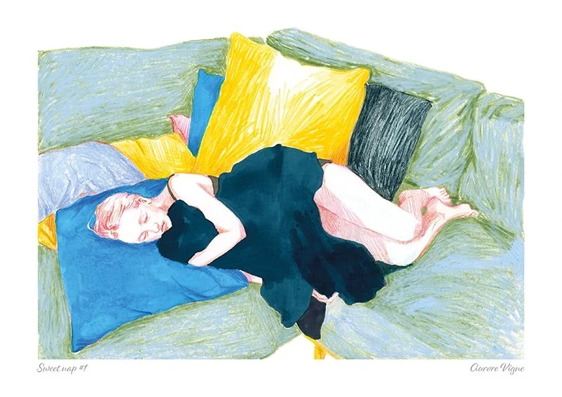 A young girl is having a sweet nap on a colored sofa.