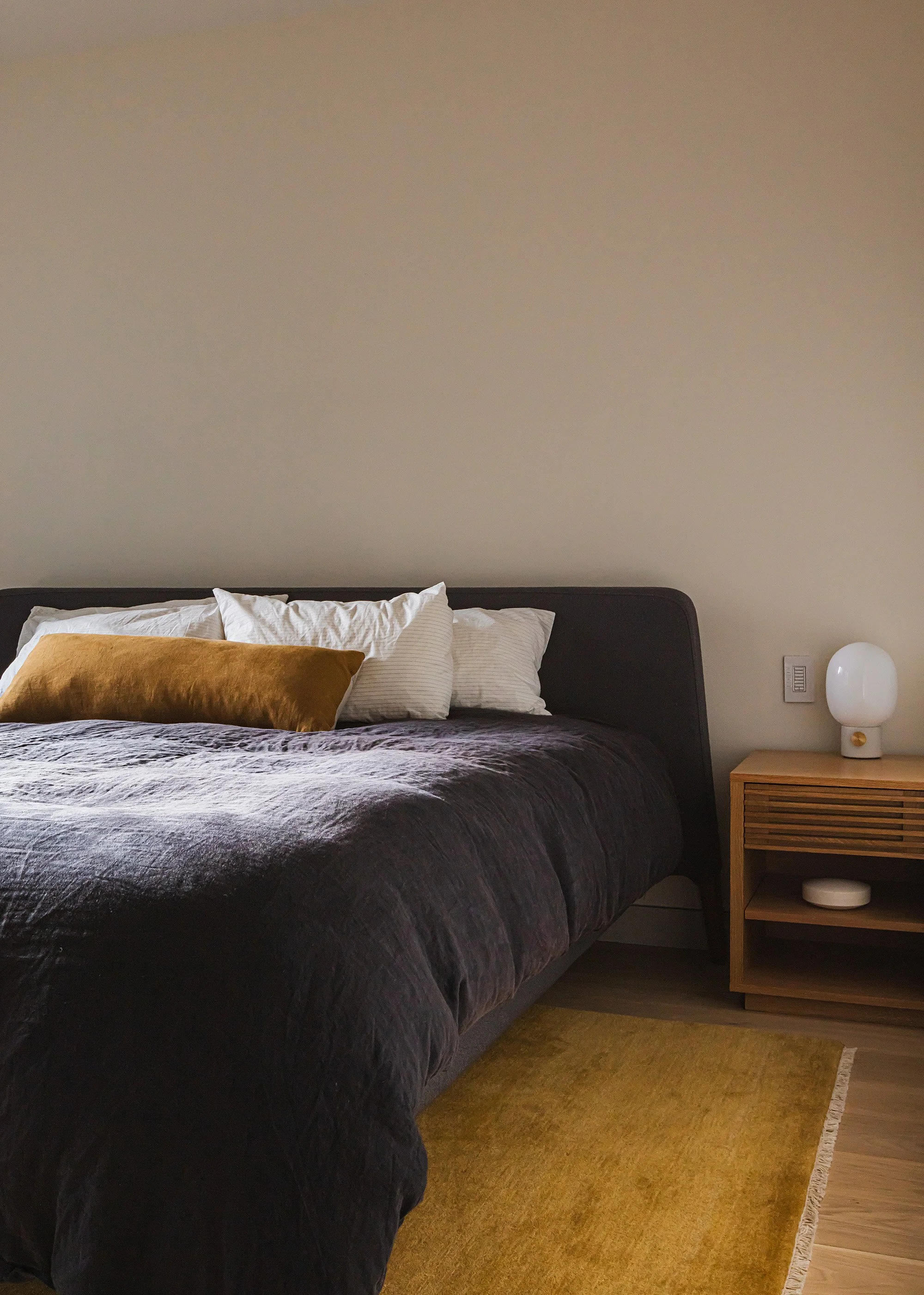 Bedroom with yellow ochre rug in a modern apartment combination project in Brooklyn