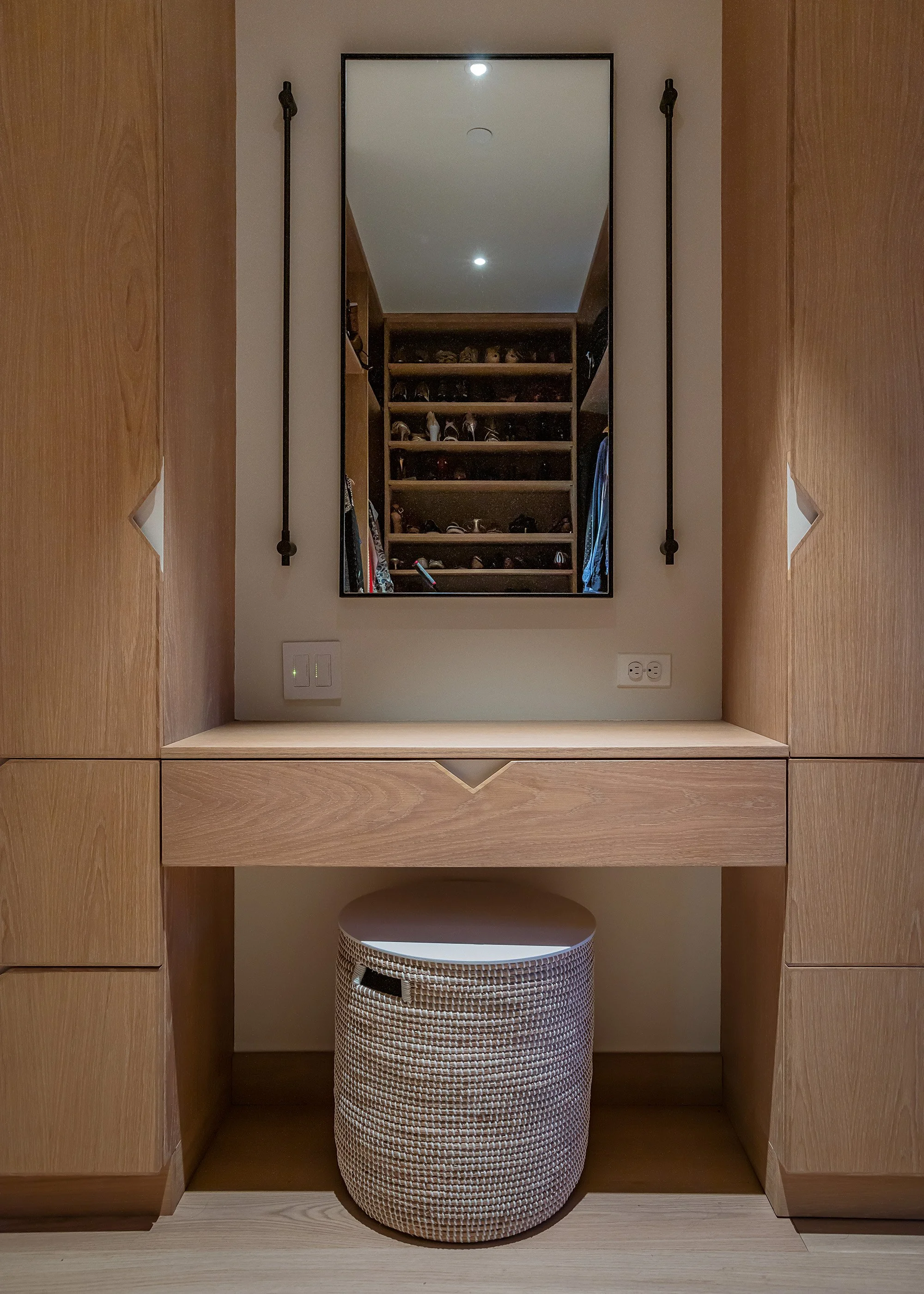 Vanity in walk-in-closet with sconces and mirror for make-up