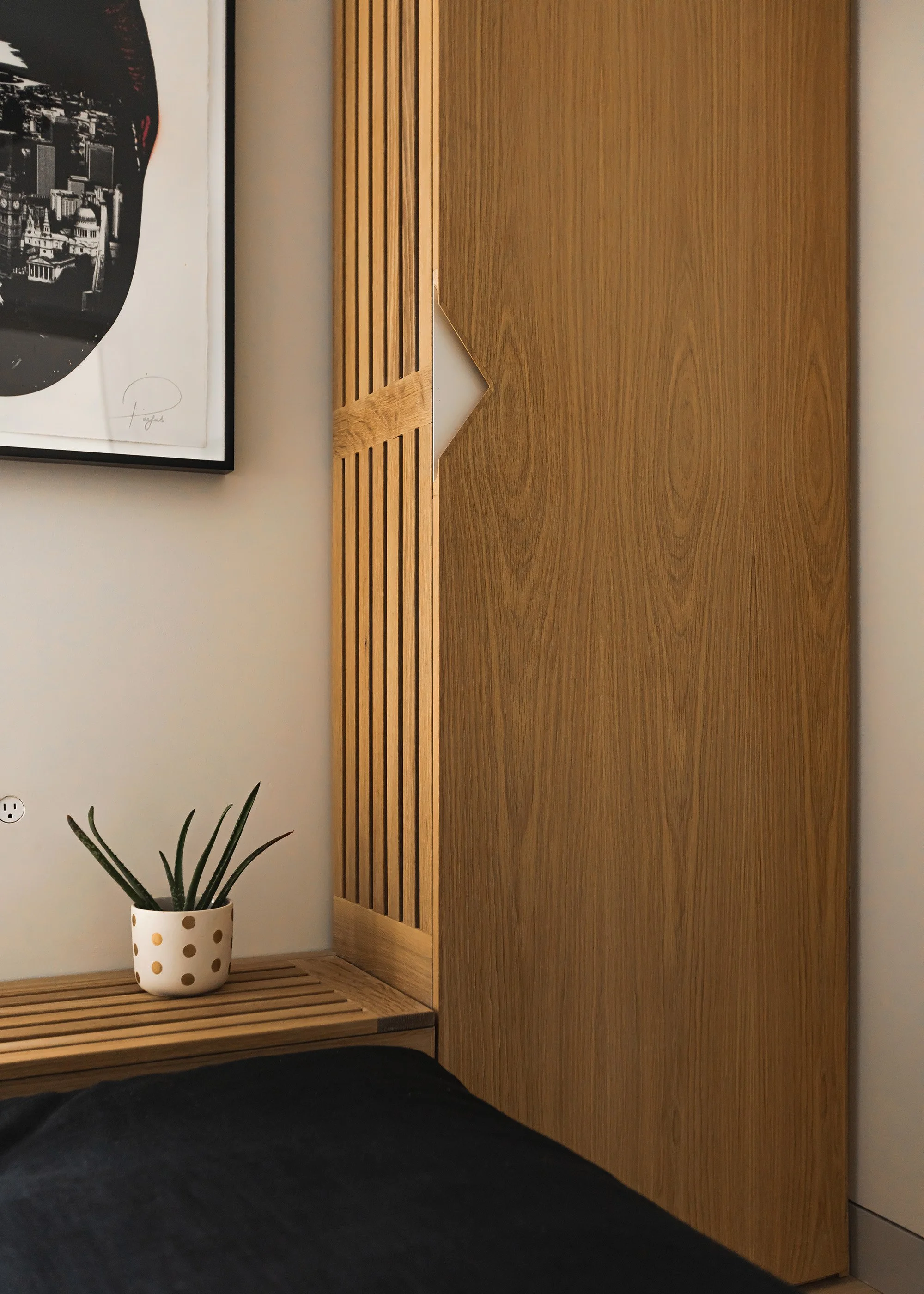 Media room storage with custom bench and slatted detail and custom integrated pull