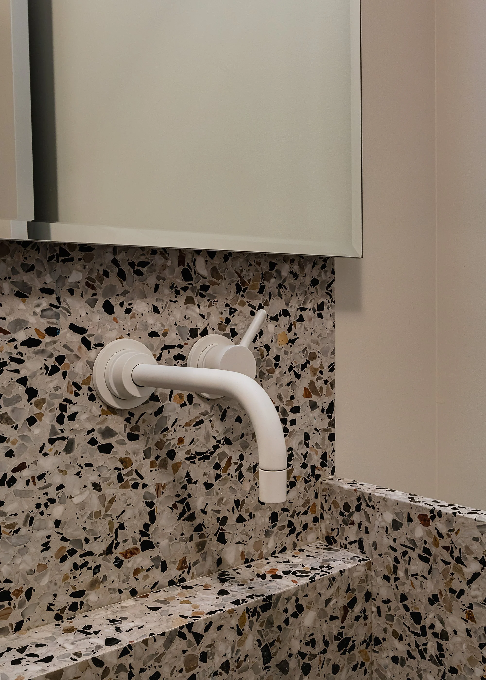 Custom terrazzo sink with white fixtures