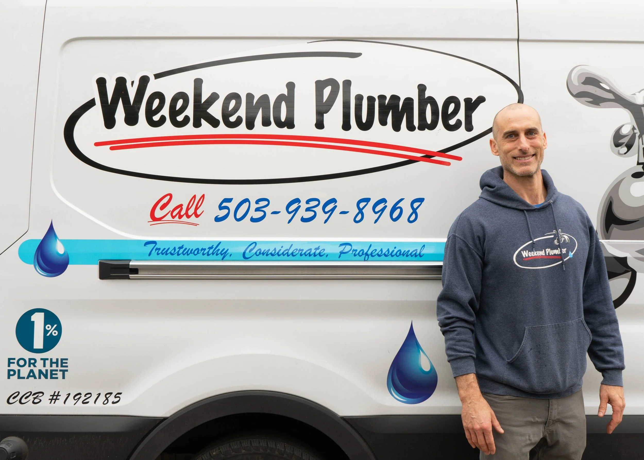 The owner of Weekend plumber standing in front of the company van