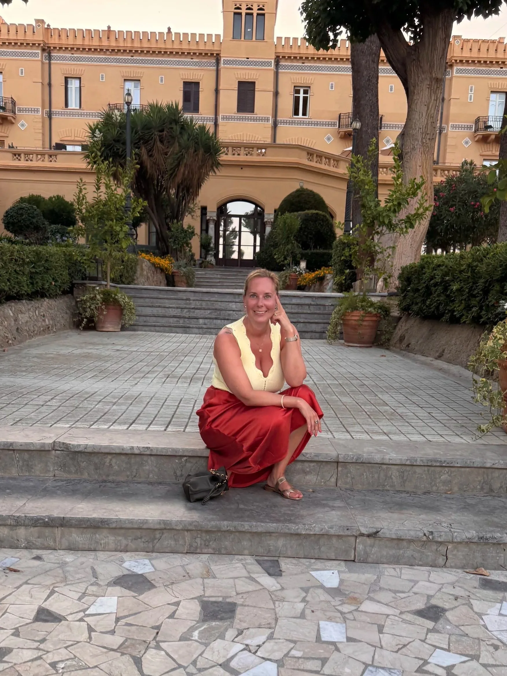 Katie Lowndes sitting On a step in Sicily