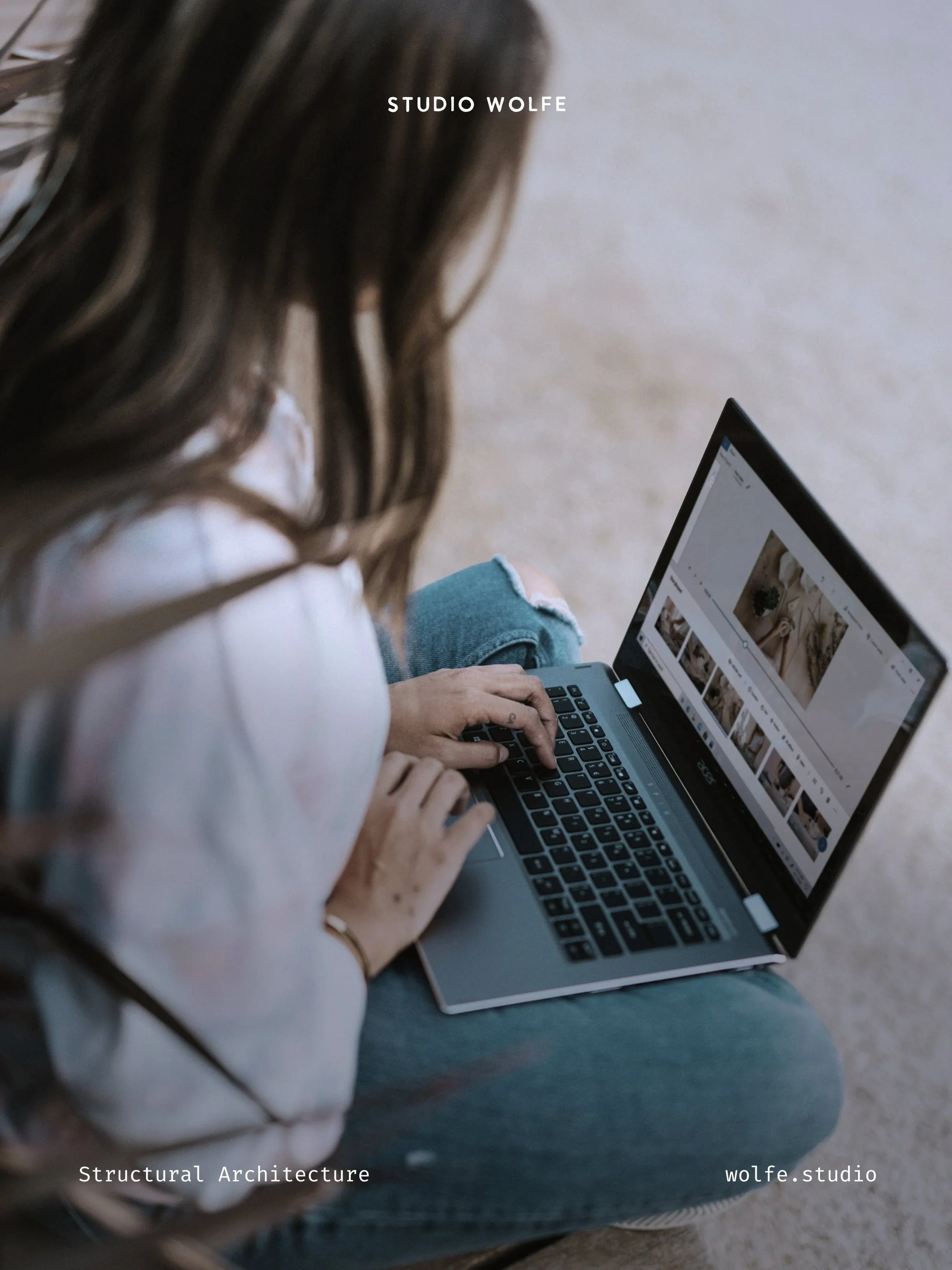 A person working on a laptop with image layouts open, representing the process of organising a digital ecosystem.