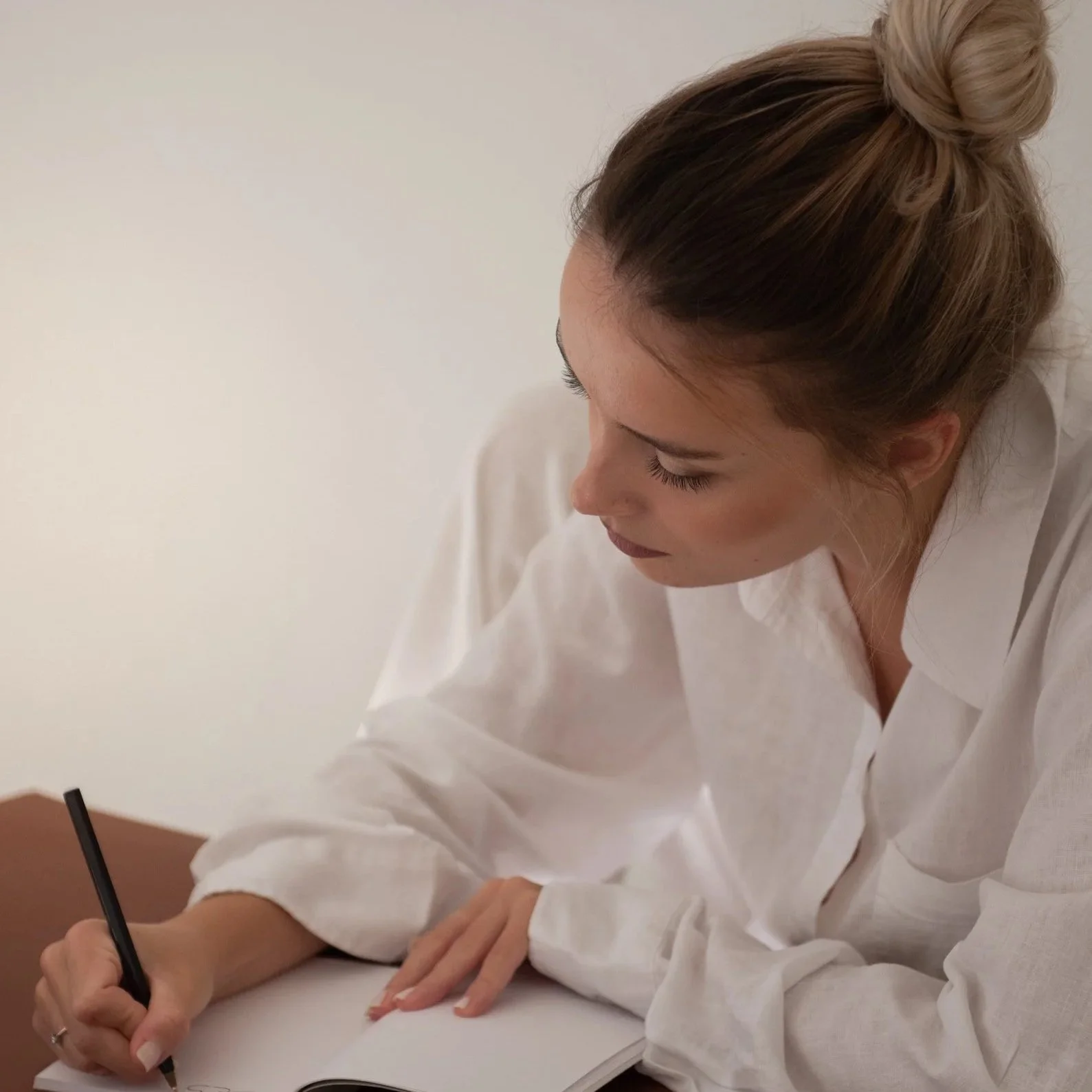young woman writing down a plan