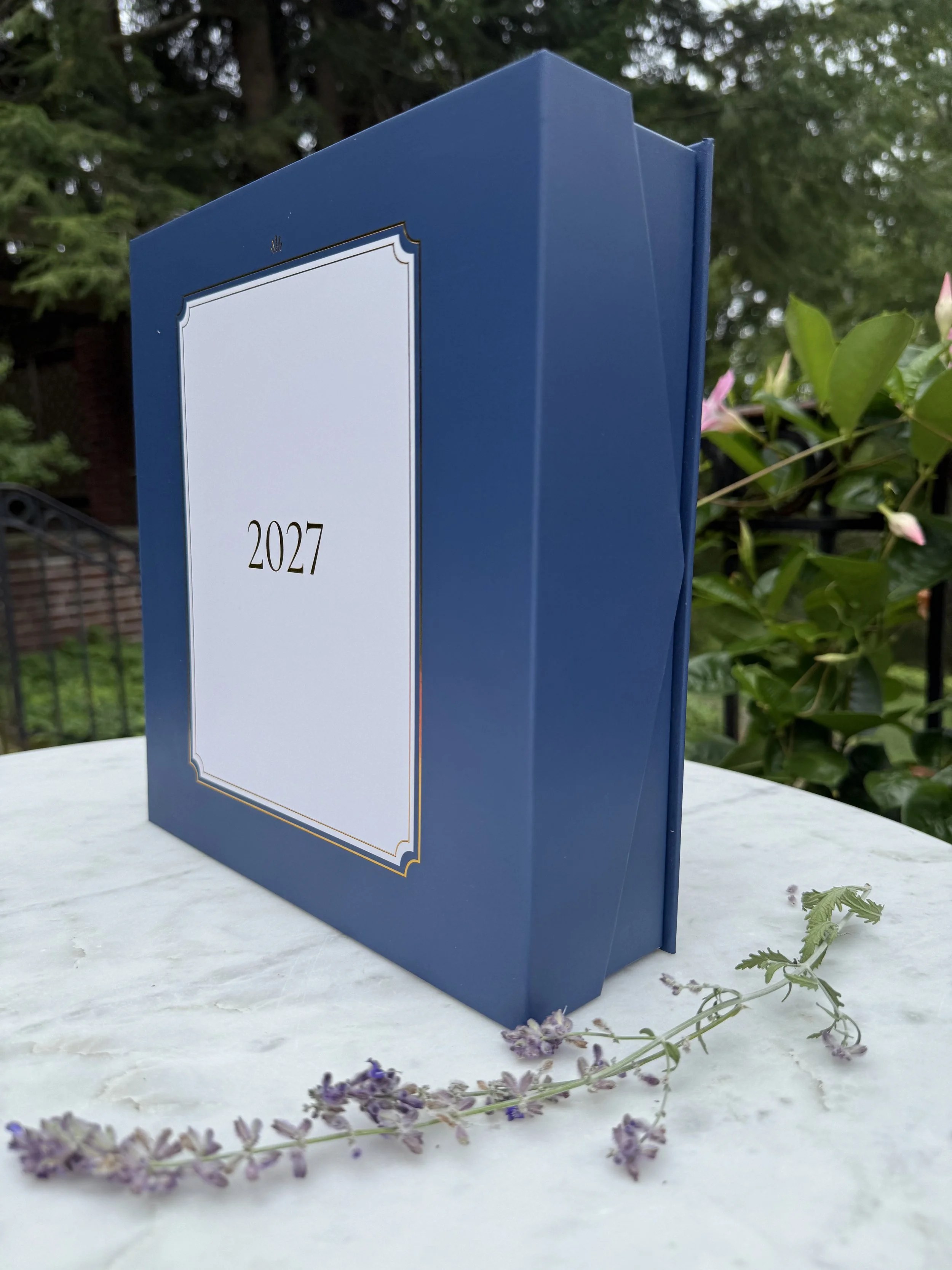 Gift box for the 2027 Lynx Point planner on a marble table with a sprig of lavender