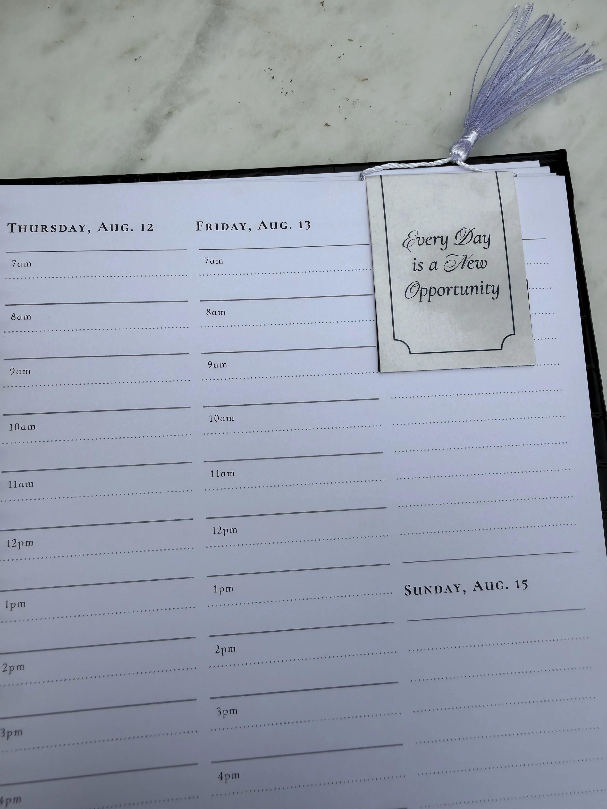 White tassel bookmark on a page of the Lynx Point Planner