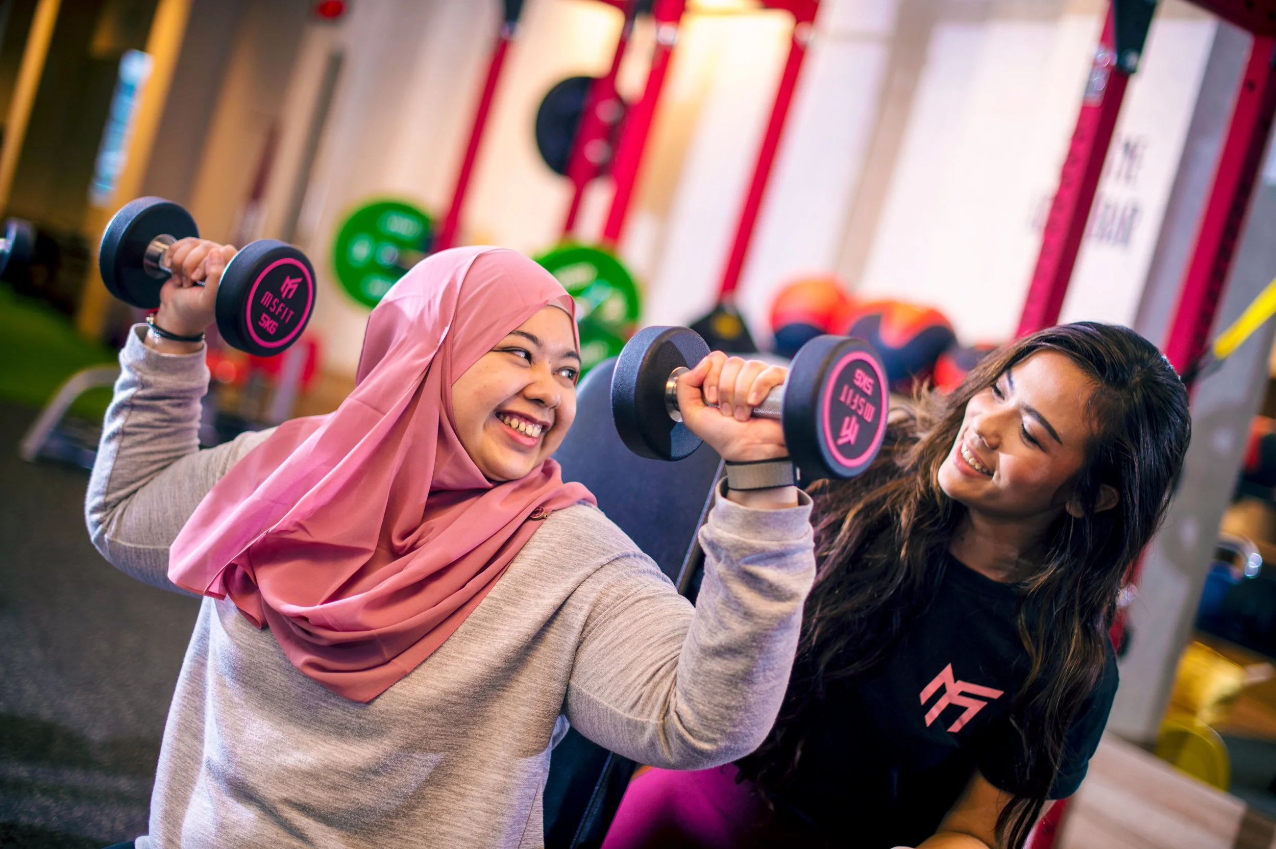 Woman lifting dumbbell during personal training at MSFIT women-only gym in Singapore