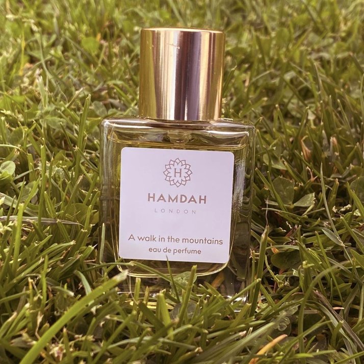 Hamdah London Luxury Bespoke Natural A Walk in the Mountains Sandalwood Unisex eau de Parfum for Men and Women in a Glass Spray Bottle on Green Grass