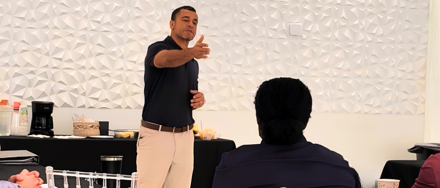 Miguel Ojeda speaking to a group at a team training event