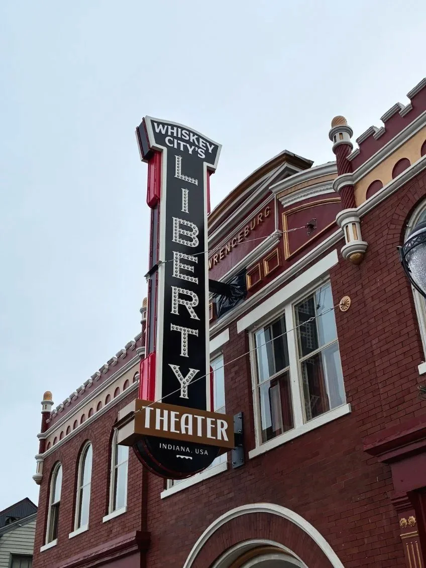 Large sign reading "Whiskey City's Liberty Theater" hangs on the side of a building. Created by Brite Line Signs in Columbus, Ohio