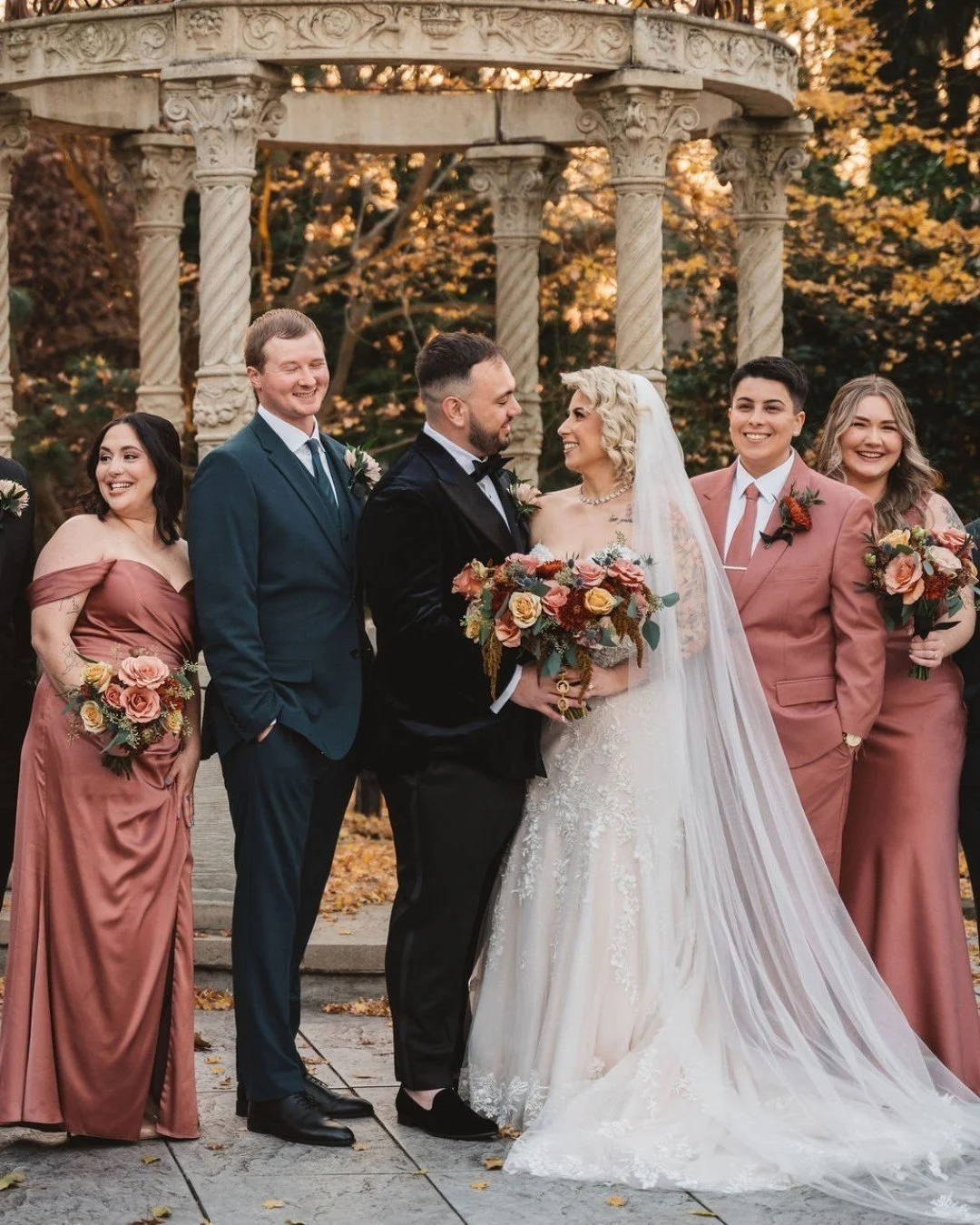 Flowers made for golden hour: Warm terracotta, rust, mauve, and golden florals paired with rich texture bring this bridal bouquet to life.

This unforgettable moment captures G + E surrounded by their closest people beneath a romantic garden pavilion