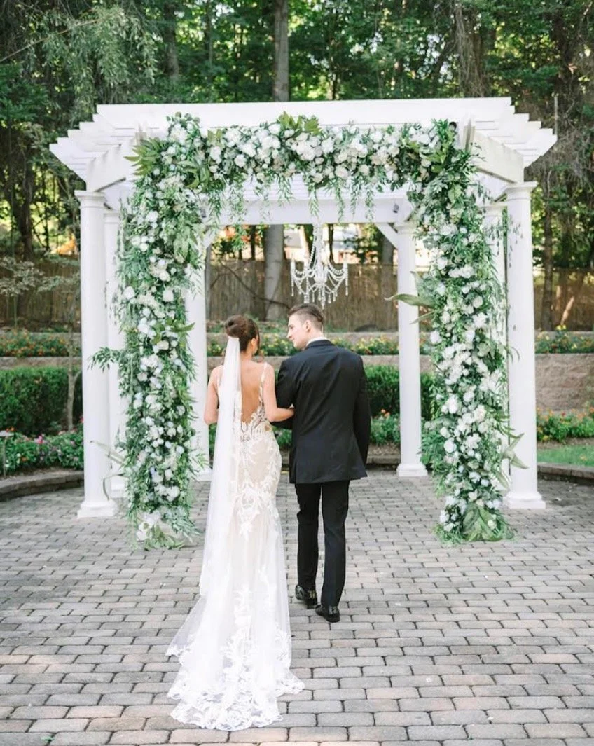 A to-be bride and groom walking to the alter