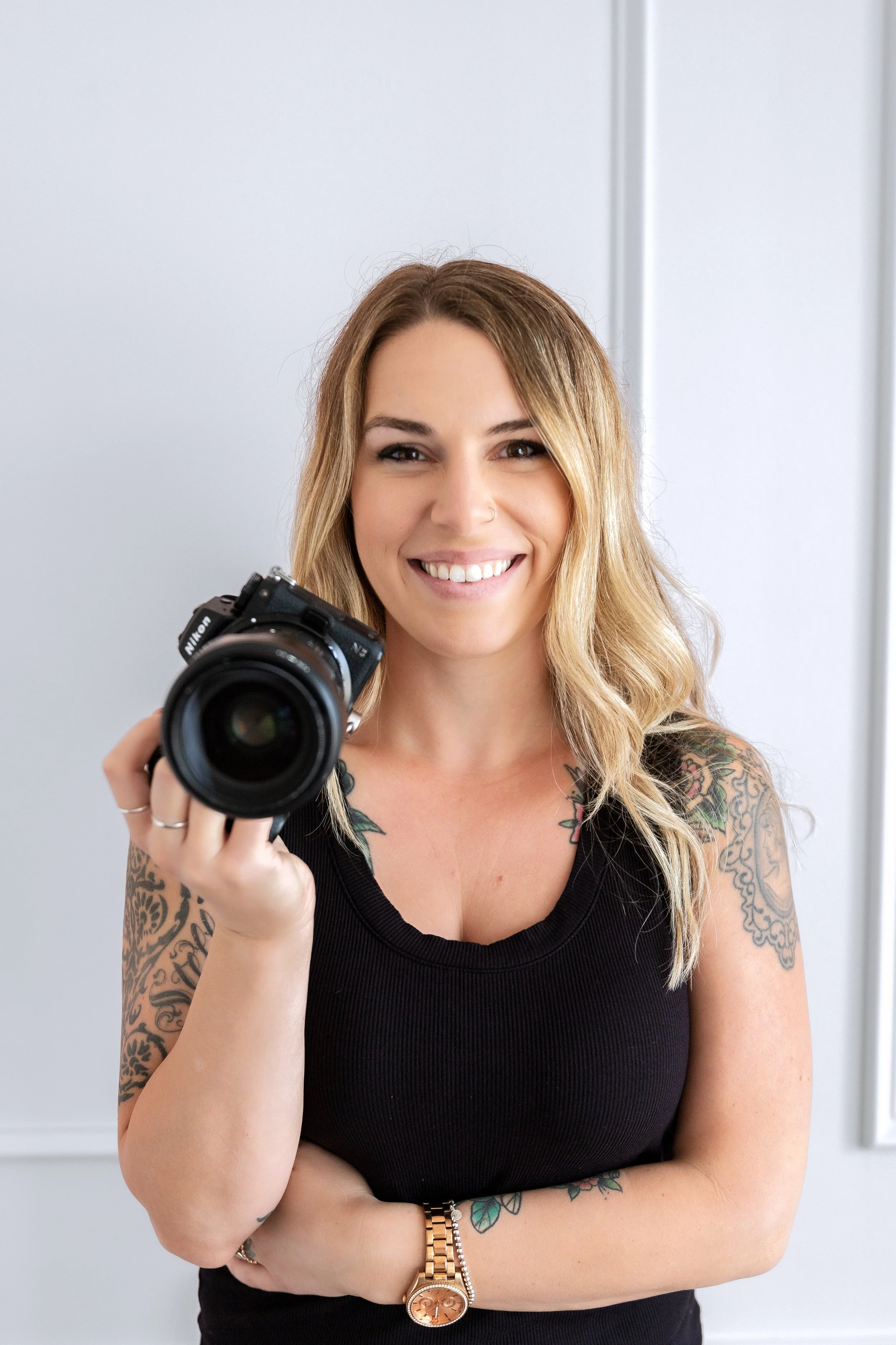 Michigan wedding photographer in photo holding camera