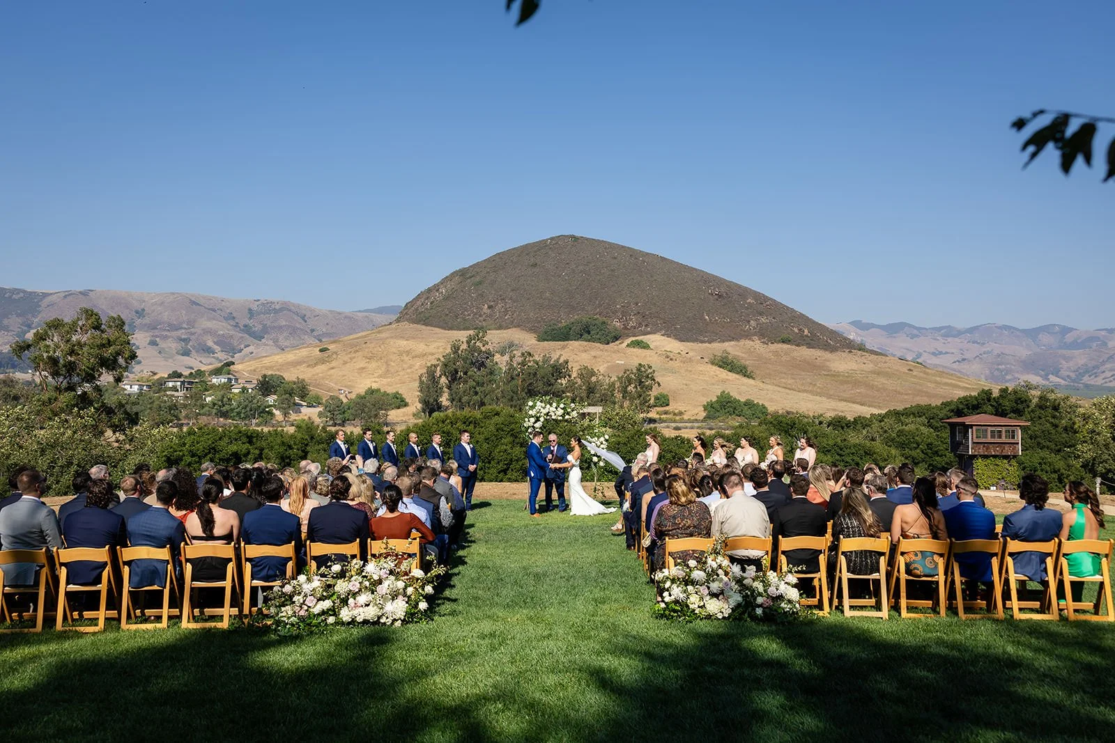 Wedding ceremony at Flying Caballos Ranch with Islay Hill in the background, San Luis Obispo, CA — photographed by Michael Stephens Photography