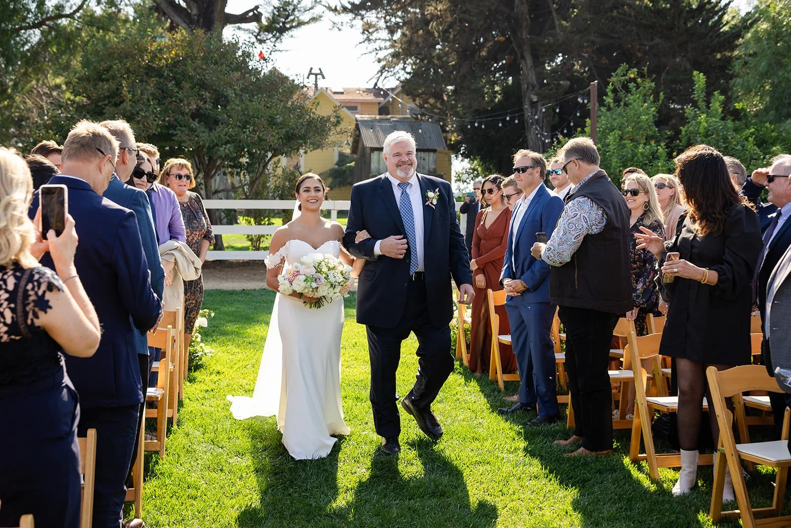 Bride walking down the aisle with her father at Flying Caballos Ranch outdoor wedding ceremony, San Luis Obispo