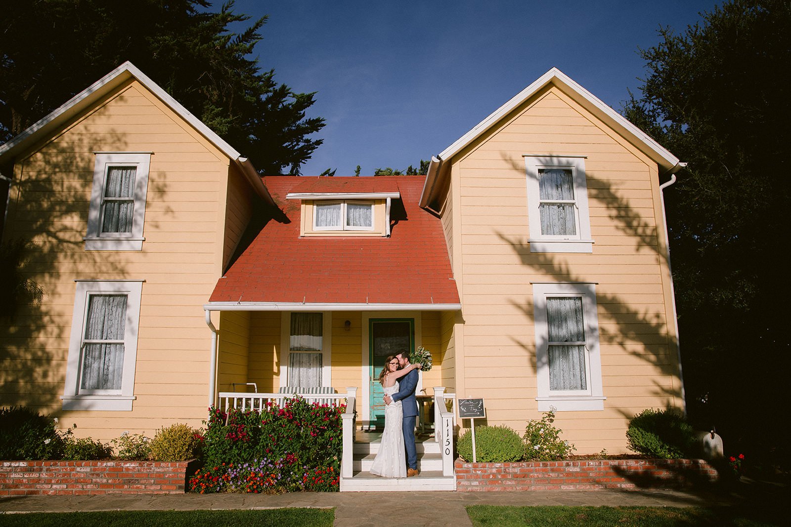 Bride and groom portrait in front of the 1905 Farmhouse at Flying Caballos Ranch, San Luis Obispo