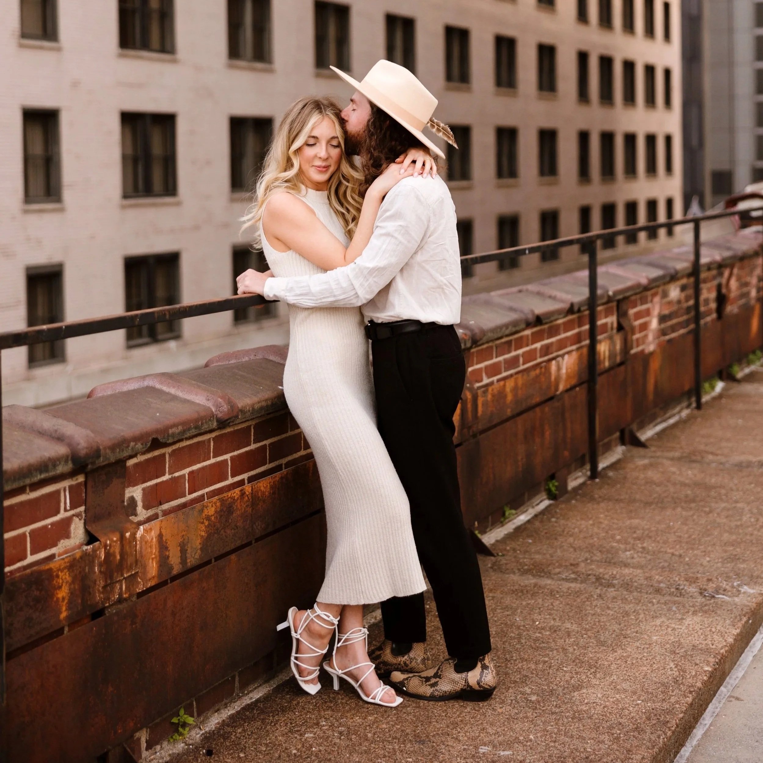 Joyful couple hugging on a rooftop in downtown Austin, celebrating their modern elopement with a relaxed and stylish vibe.