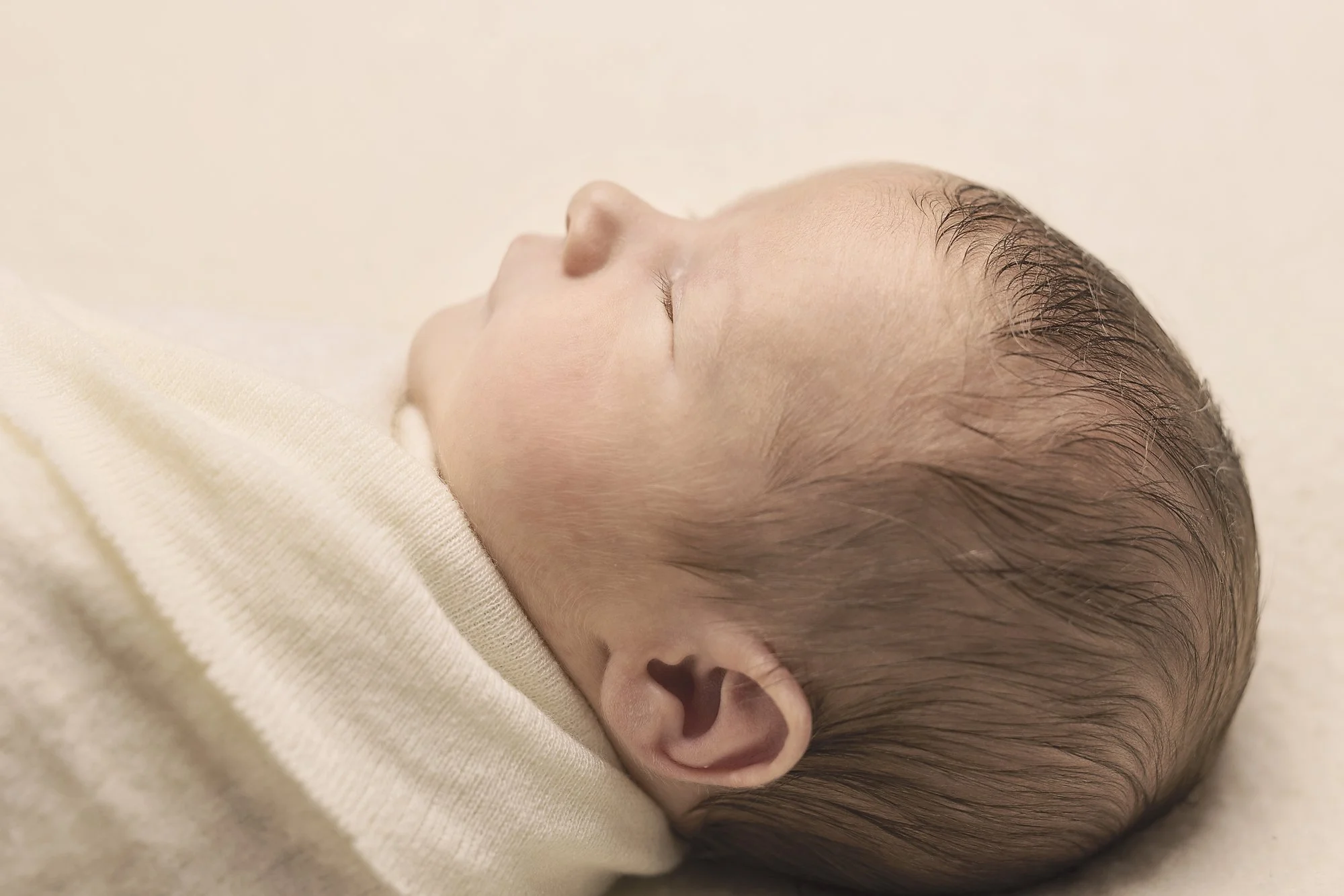 newborn baby boy asleep on cream side profile wrapped photography penrith blue mountains western sydney hills district