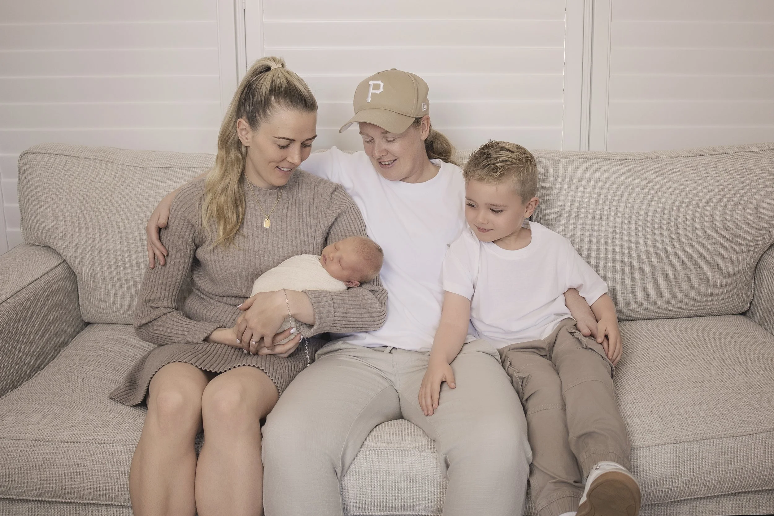 affordable newborn family photo on couch at home