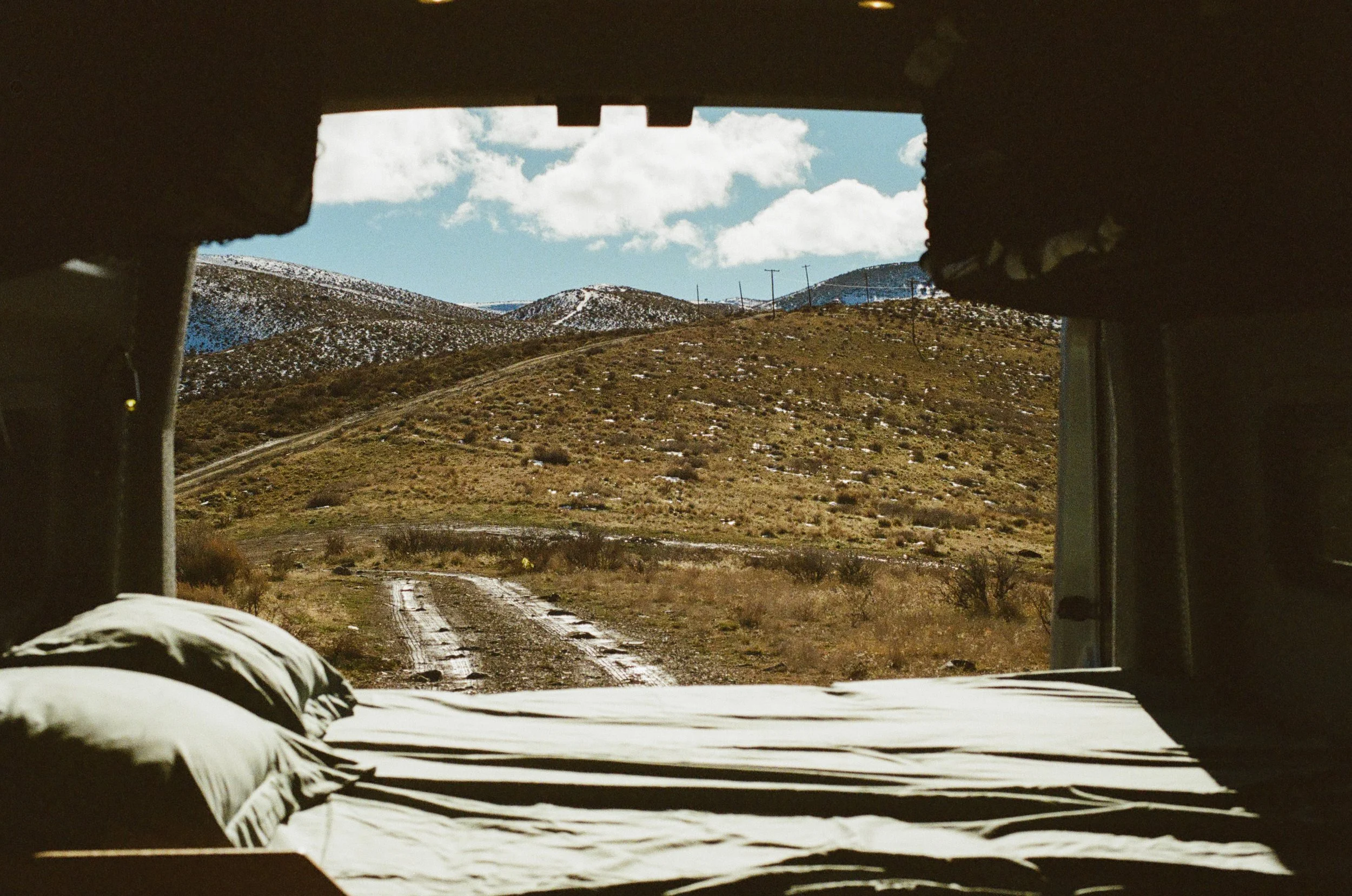 camper-van-bed-view-remote-dirt-road.jpg