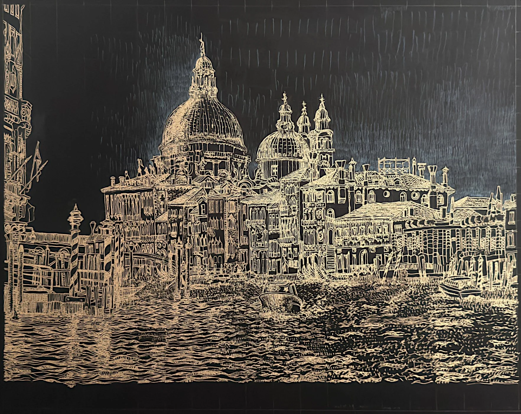 A detailed gold ink illustration of Santa Maria della Salute in Venice, drawn on black cardboard. The domes, waterfront buildings, canal posts, boats, and textured water are rendered in fine luminous lines against a dark background.