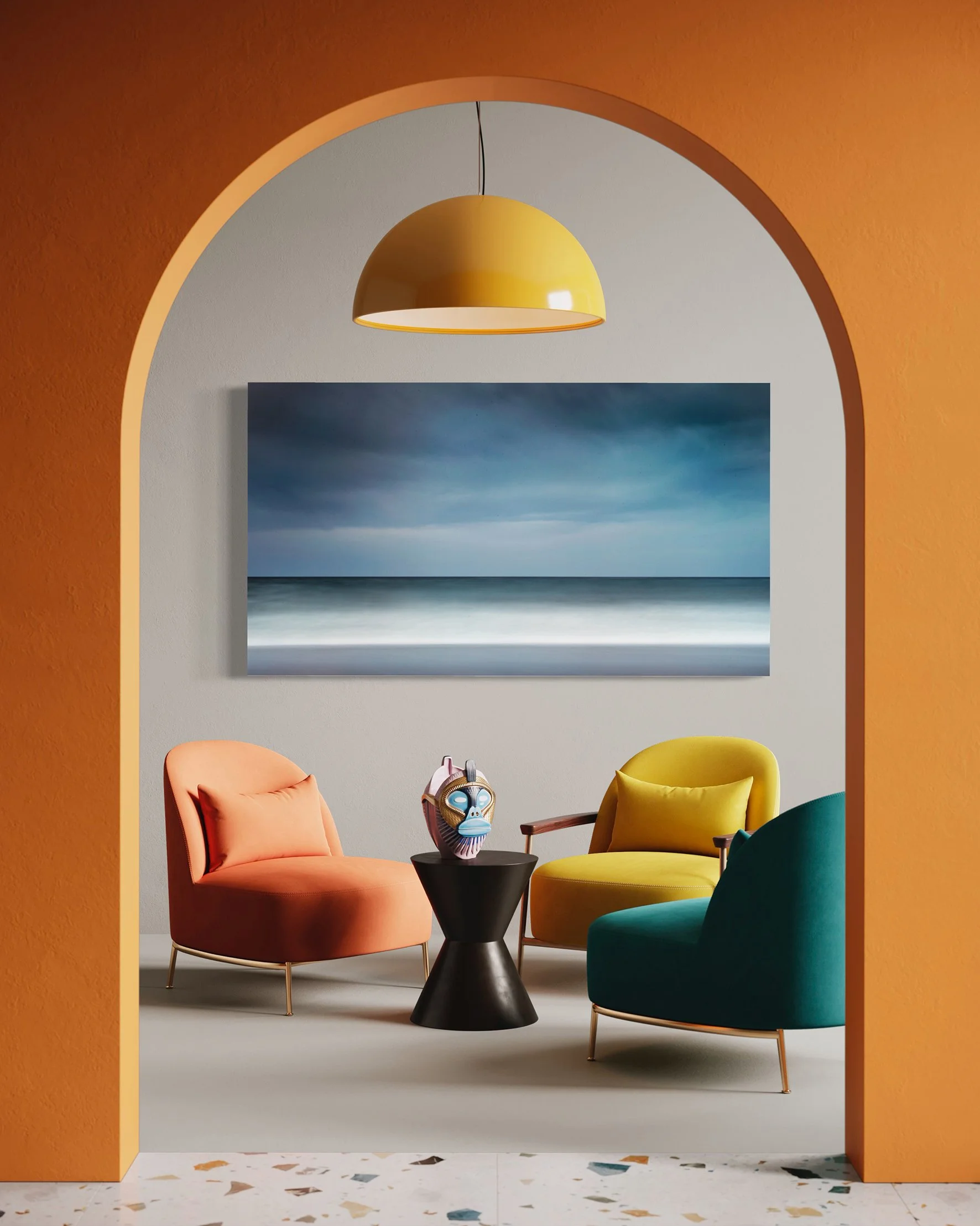 A cozy living room with pastel-colored armchairs in pink, yellow, and teal around a black side table, with a decorative mask on top. A large seascape painting depicting a stormy sky and ocean hangs on the wall. The room is viewed through an arched doorway painted peach, with a yellow pendant light hanging above.
