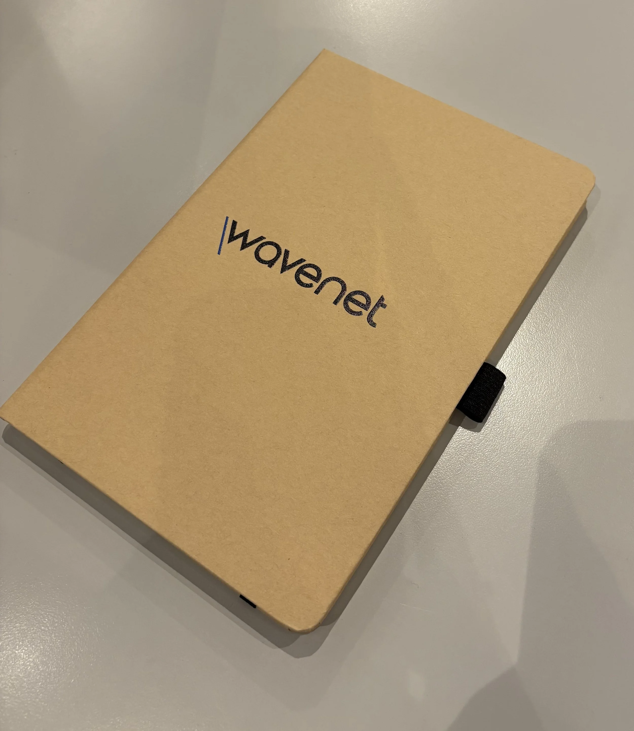 brown notebook with 'wavenet' on the front