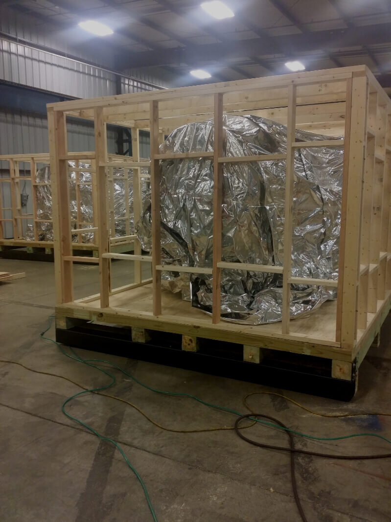 industrial vacuum sealing freight with foil vapor barrier on custom wood crating