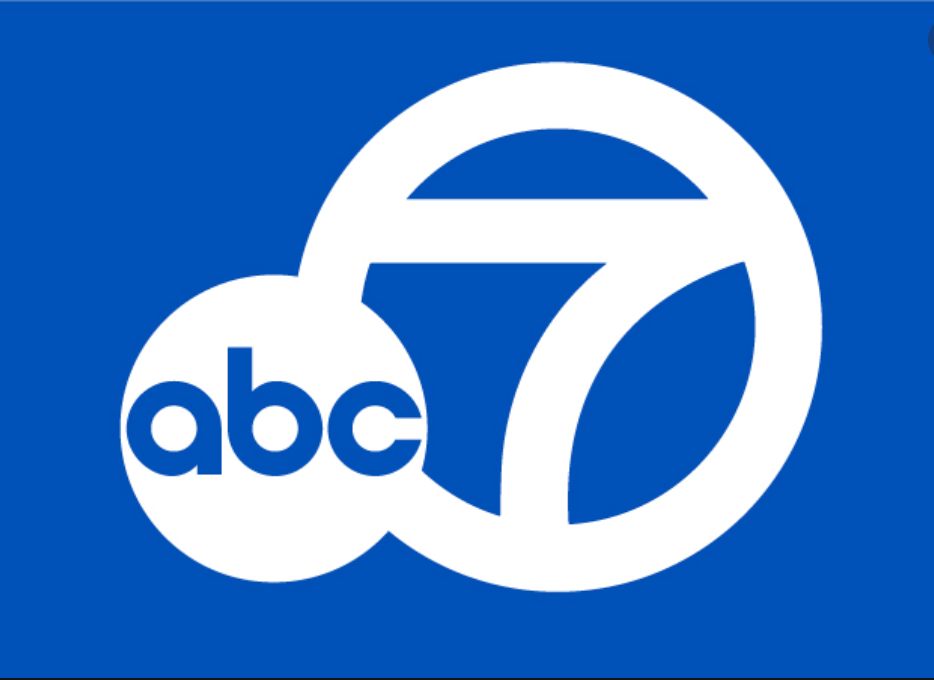 Blue background with white logo of ABC 7, featuring a stylized number 7 with the ABC letters inside a circular design.