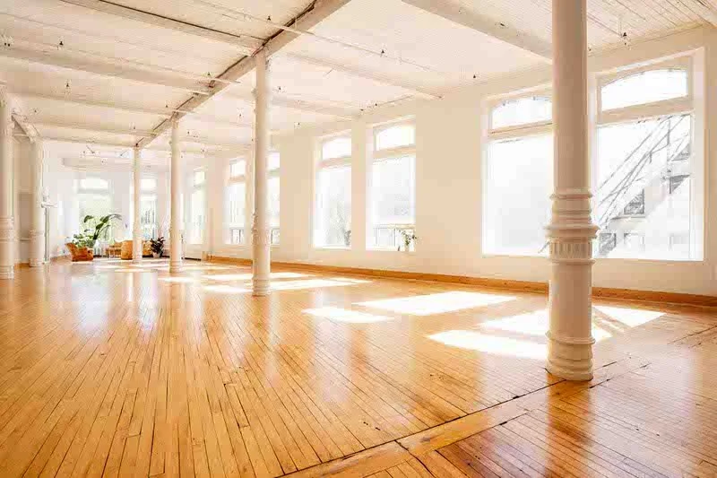 Spacious natural light photography studio with hardwood floors and large windows in Winnipeg's Exchange District – 204 Photography