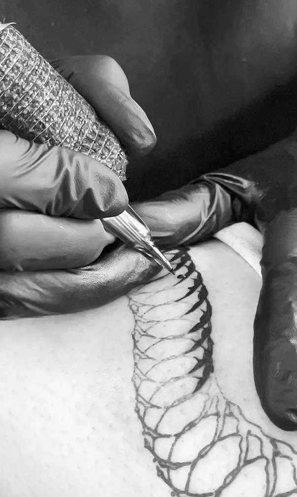 Once the flow is finalized and the design is complete, the tattooing process begins, turning the design into a permanent piece.