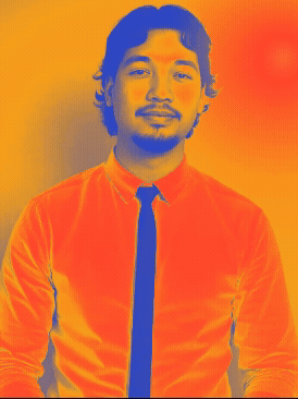 Black and white portrait of a young man with curly hair, a goatee, wearing a white dress shirt and a dark tie, smiling slightly, against a plain background.