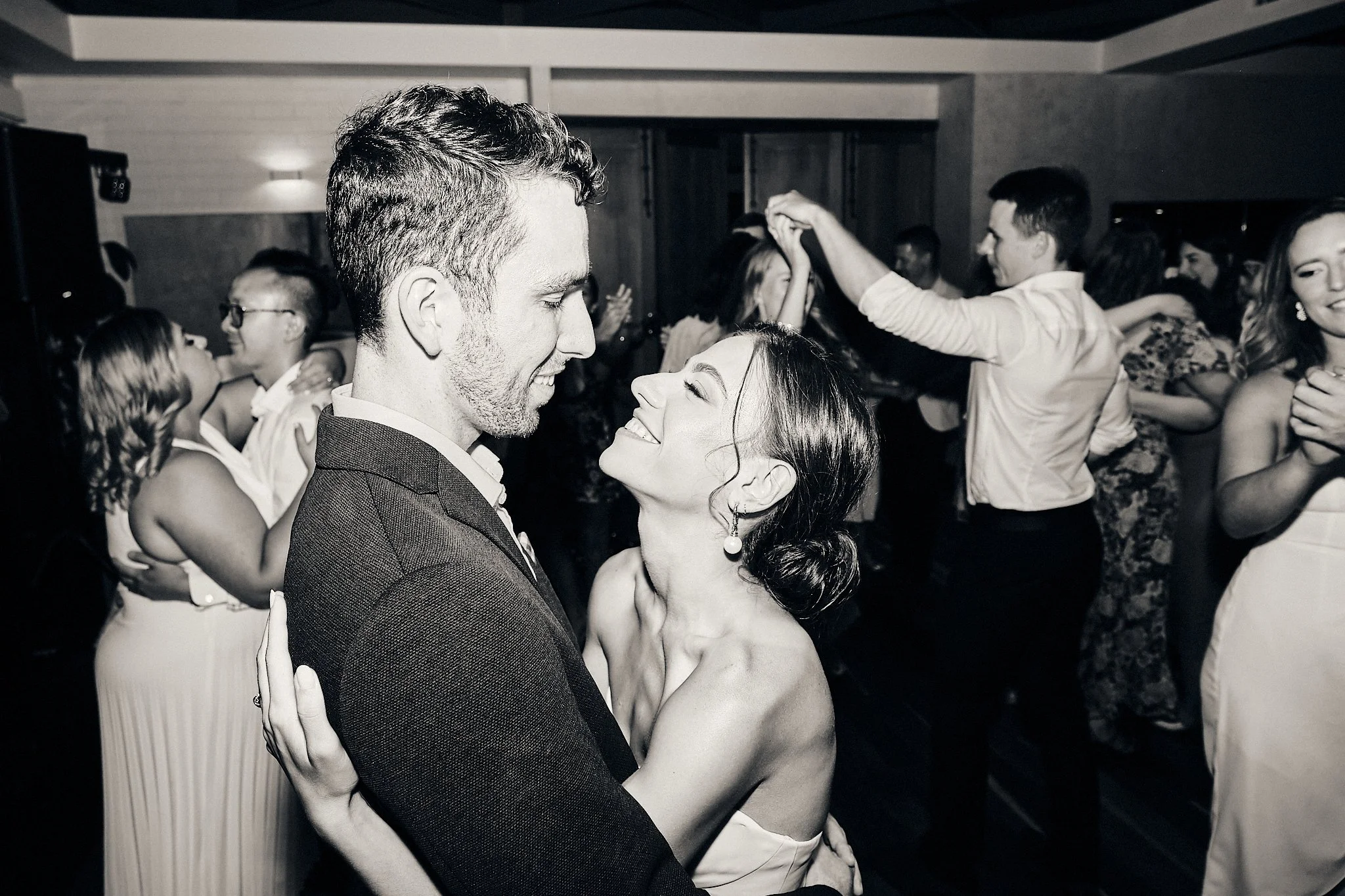 Stylistic, black and white image of a bride and groom dancing