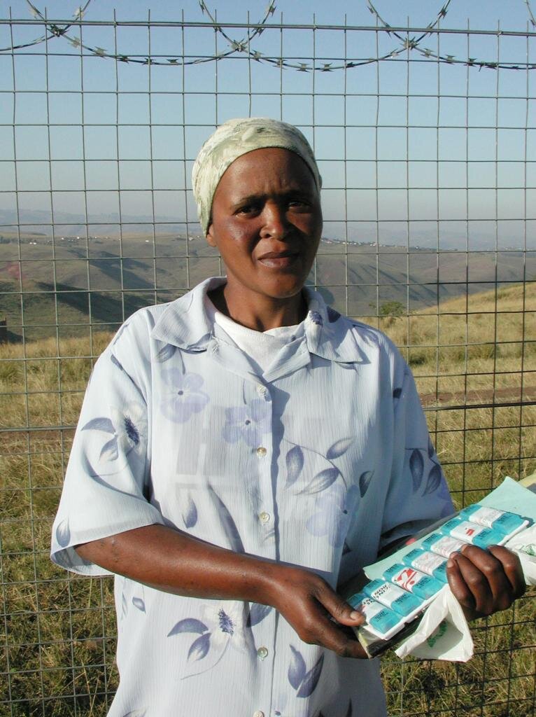 Nozuko Mavuka, an HIV-positive mother in the Lusikisiki district of South Africa’s Eastern Cape, clutches the pillbox that restored her failing health. Mavuka is one of several hundred villagers receiving antiretroviral treatment through a community…