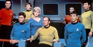 The crew of Star Trek on the bridge of the star ship
