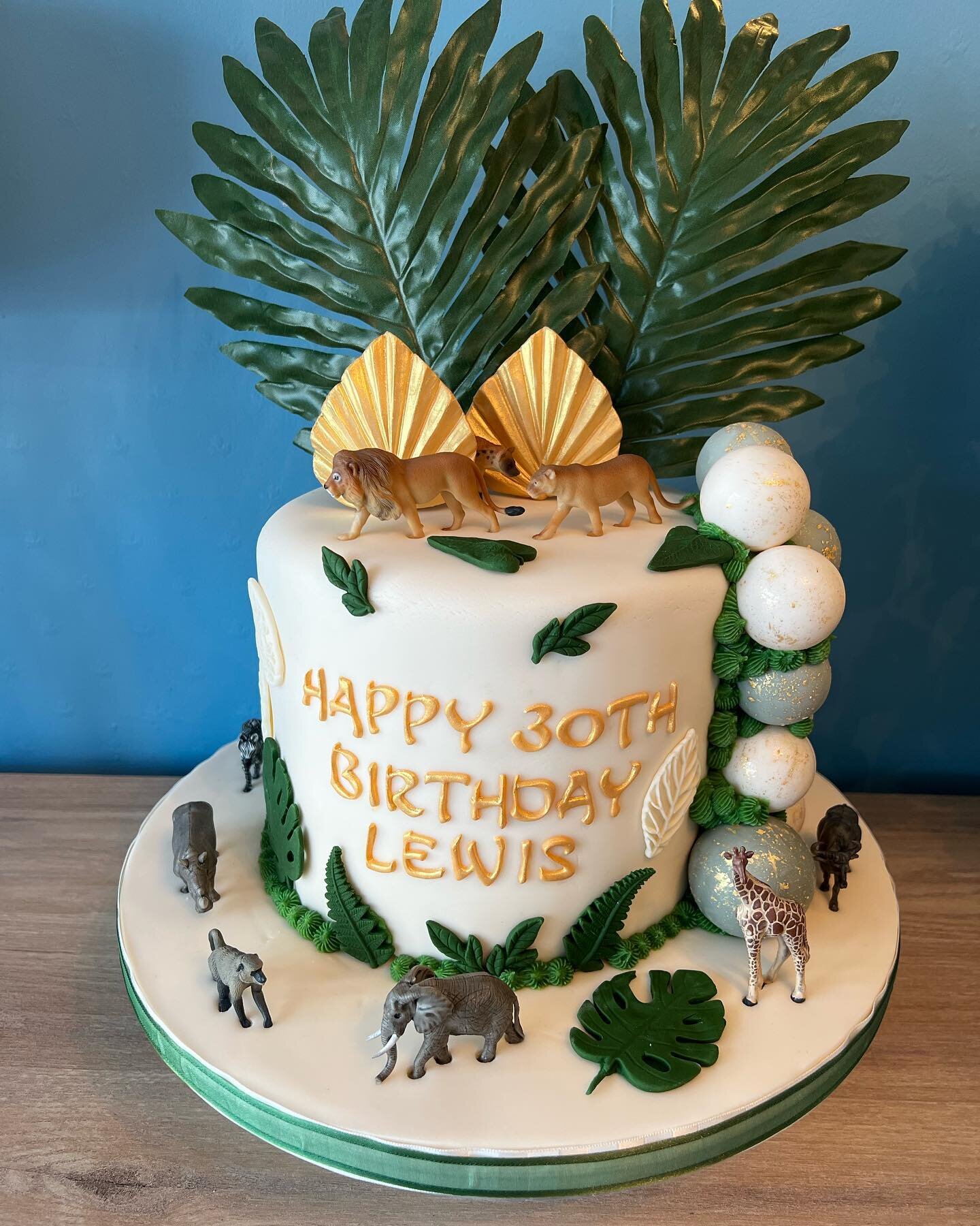 Lewis had a vanilla flavoured Safari cake for his 30th Birthday, decorated on one side with coloured chocolate balls, green and gold palm leaves and safari animals.  Hope you had a great day x