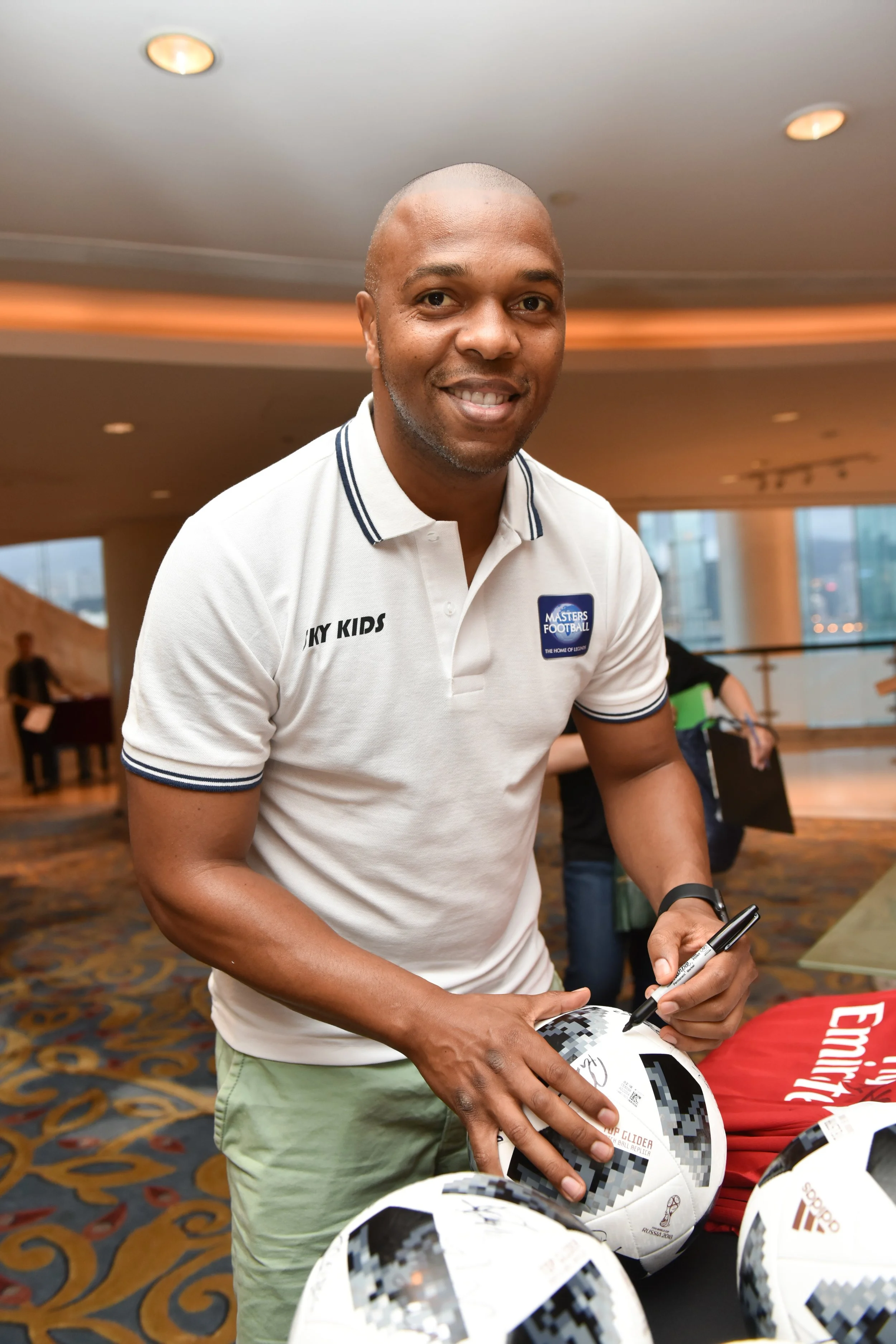 Quinton Fortune signs ball.jpg