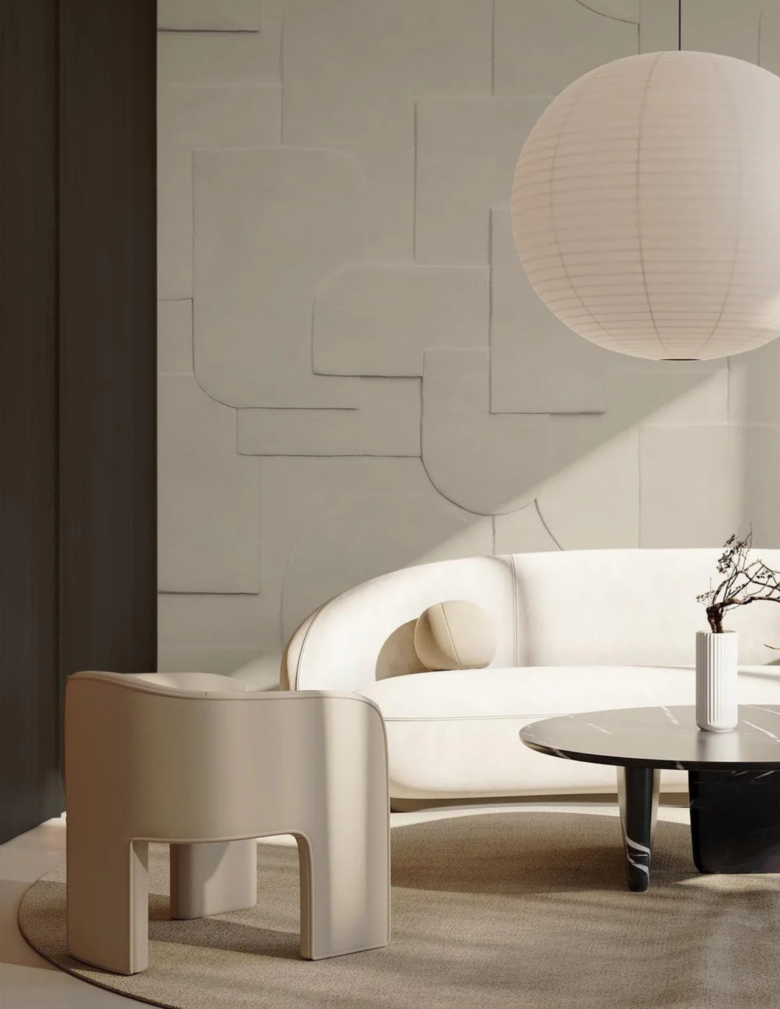 Modern, minimalist living room with white curved sofa, round black coffee table, large paper lantern ceiling light, and textured white wall with line art. Potted plant on side table.