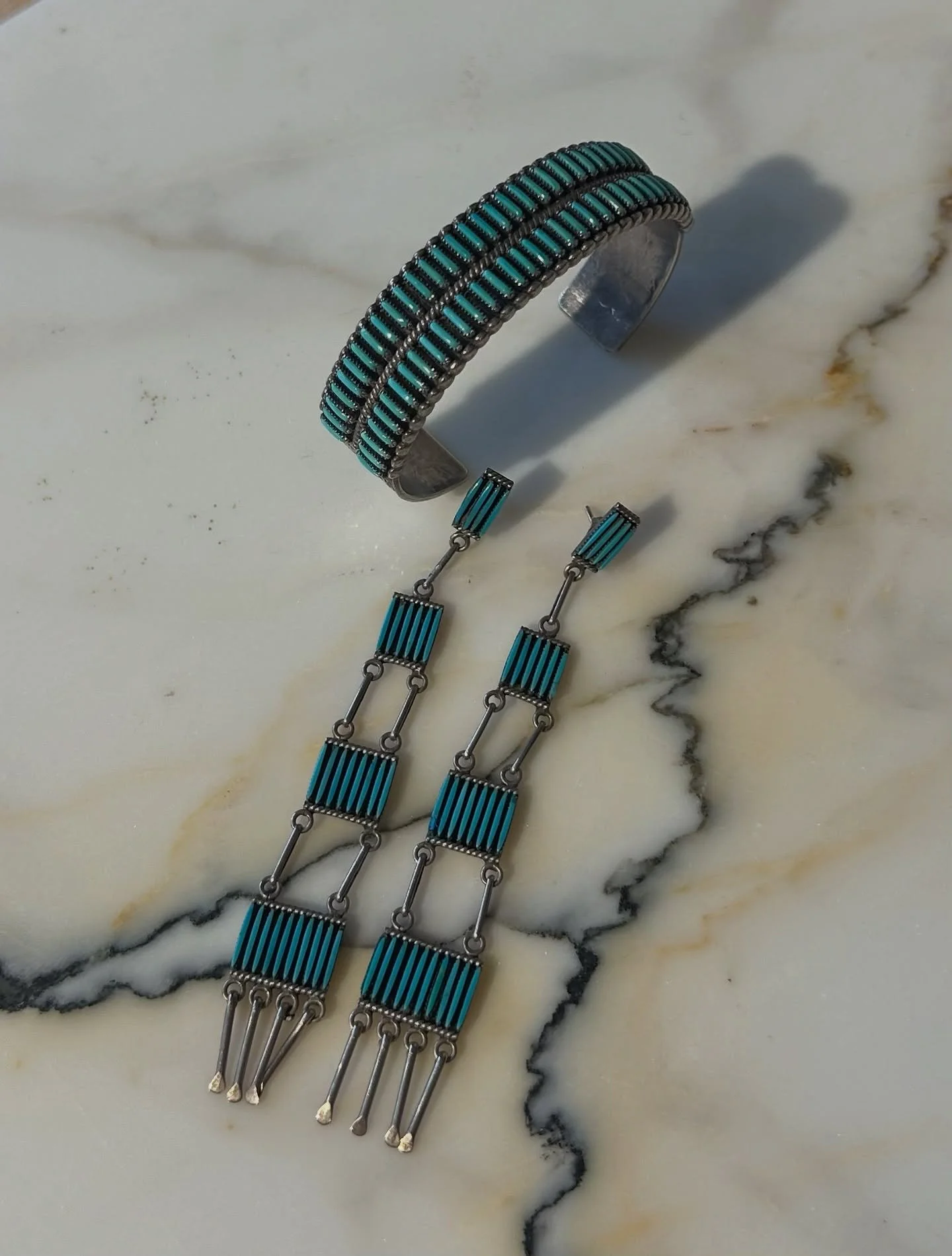 These are not a set but wow they look good together 
Vintage signed Zuni double petite point stamped cuff and 4&quot; Zuni signed petite point chandeliers.