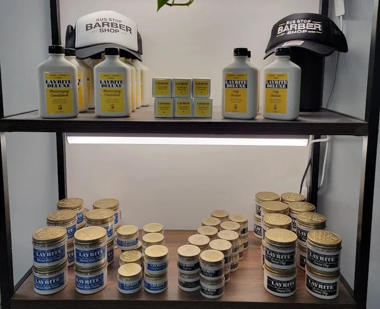 Shelves of Layrite hair products at The Bus Stop Barbershop in SoMa, San Francisco, including matte cream, original clay, moisturizing conditioner, and daily shampoo.