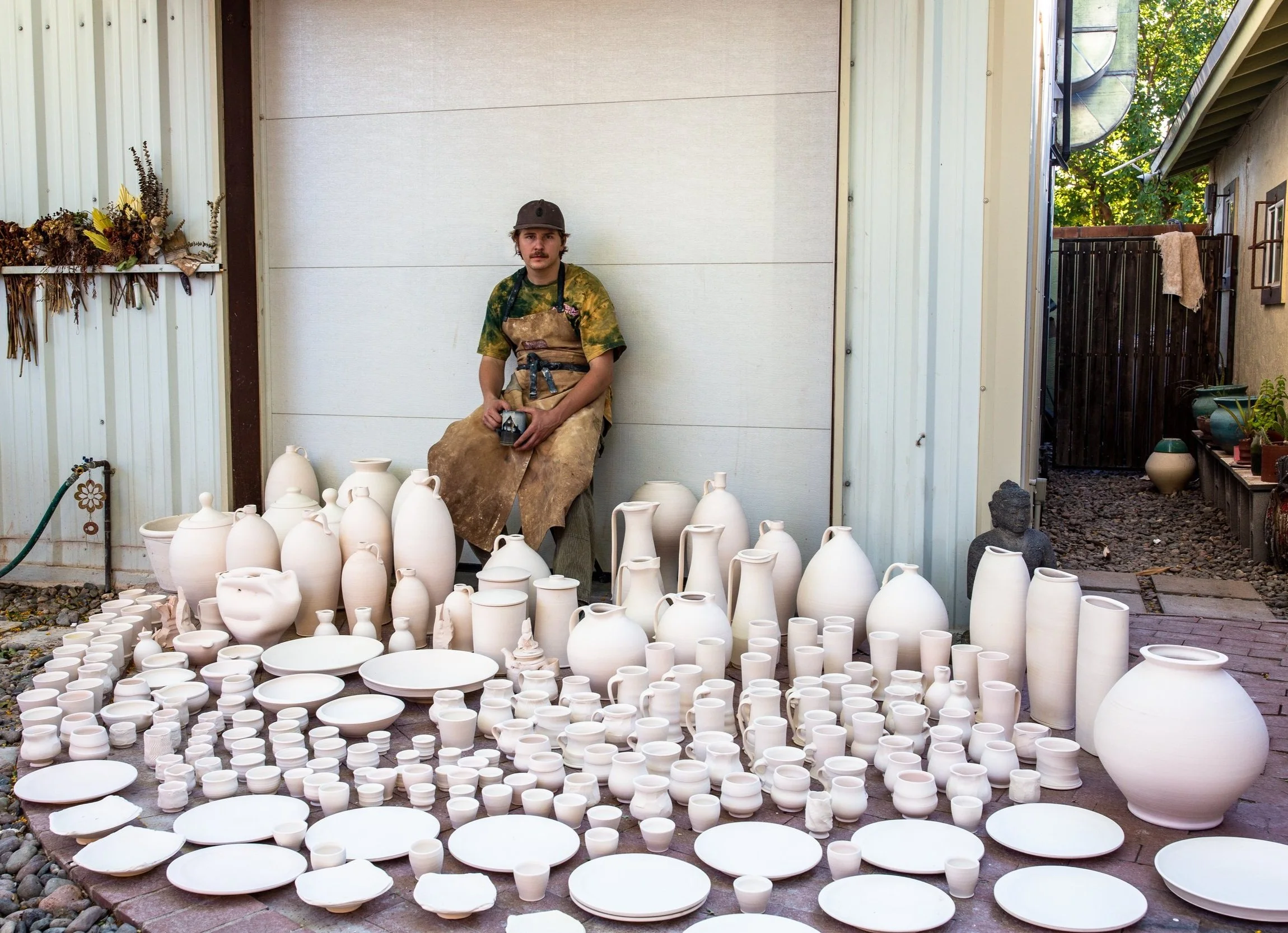 Andrew Smith surrounded by ceramic work in the Augusta Pots studio