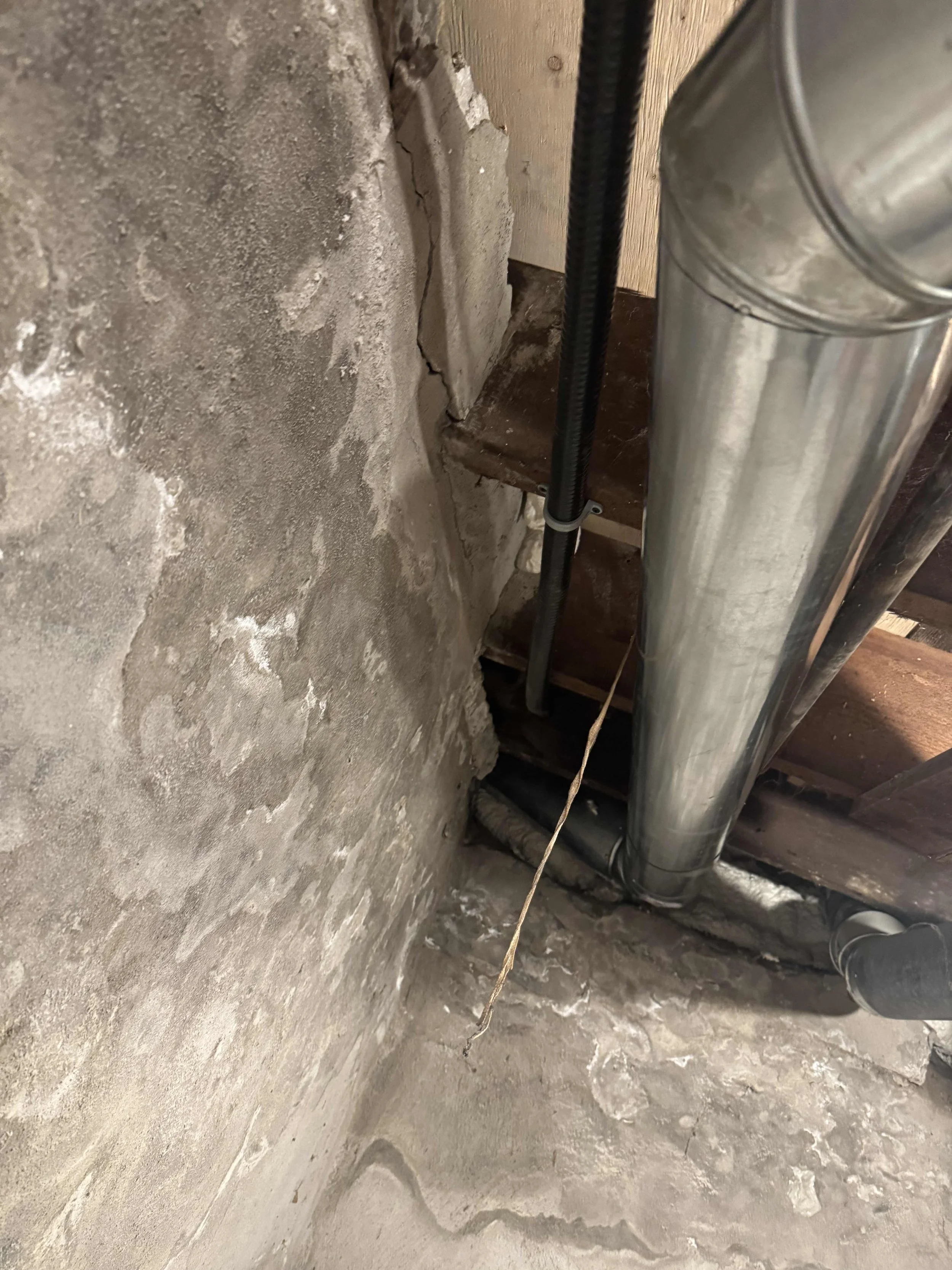 Conduit run through basement wall during residential EV charger circuit installation in Brockville Ontario