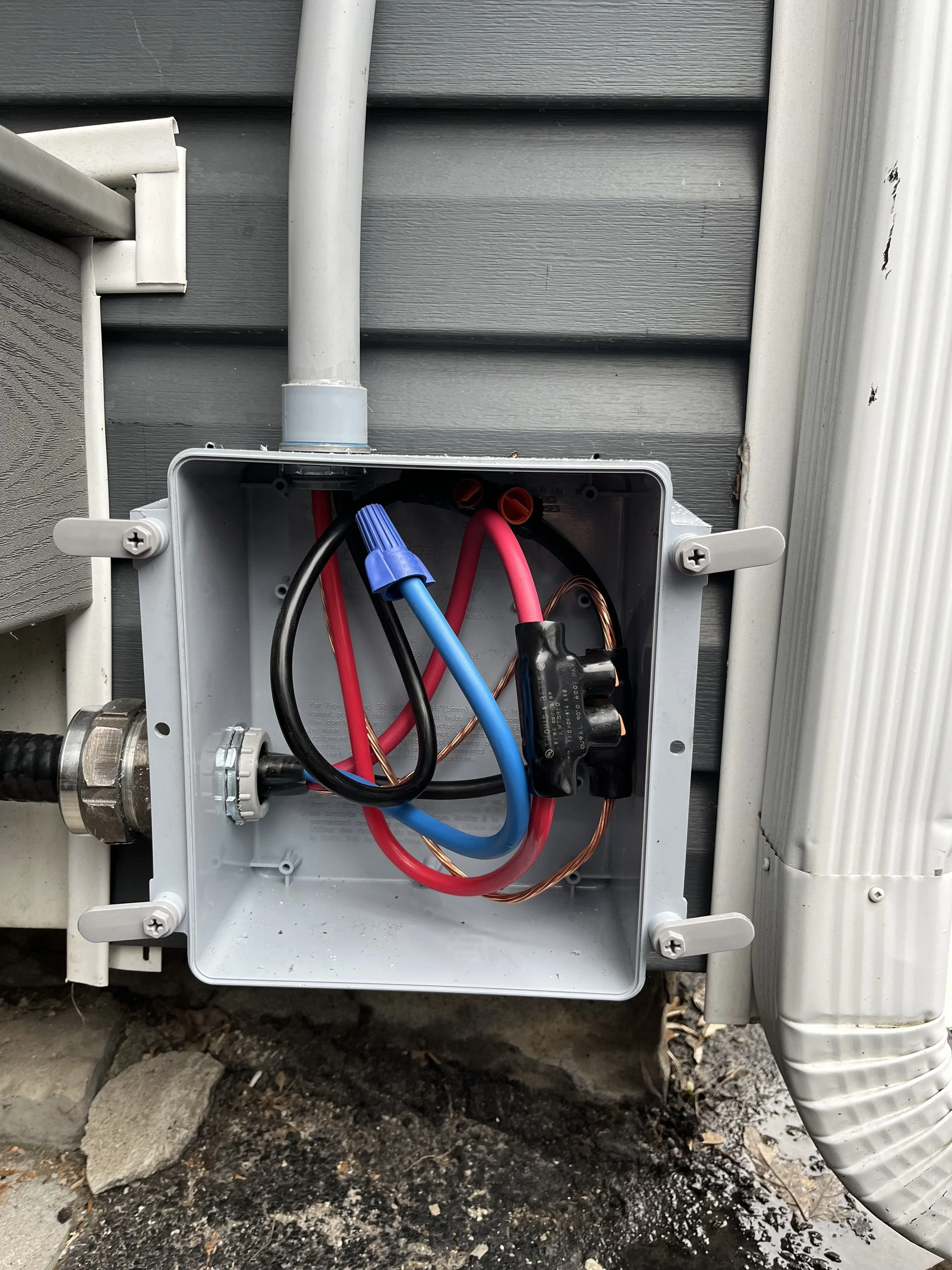 Weatherproof exterior junction box wired for Level 2 EV charger installation by licensed electricians in Ontario
