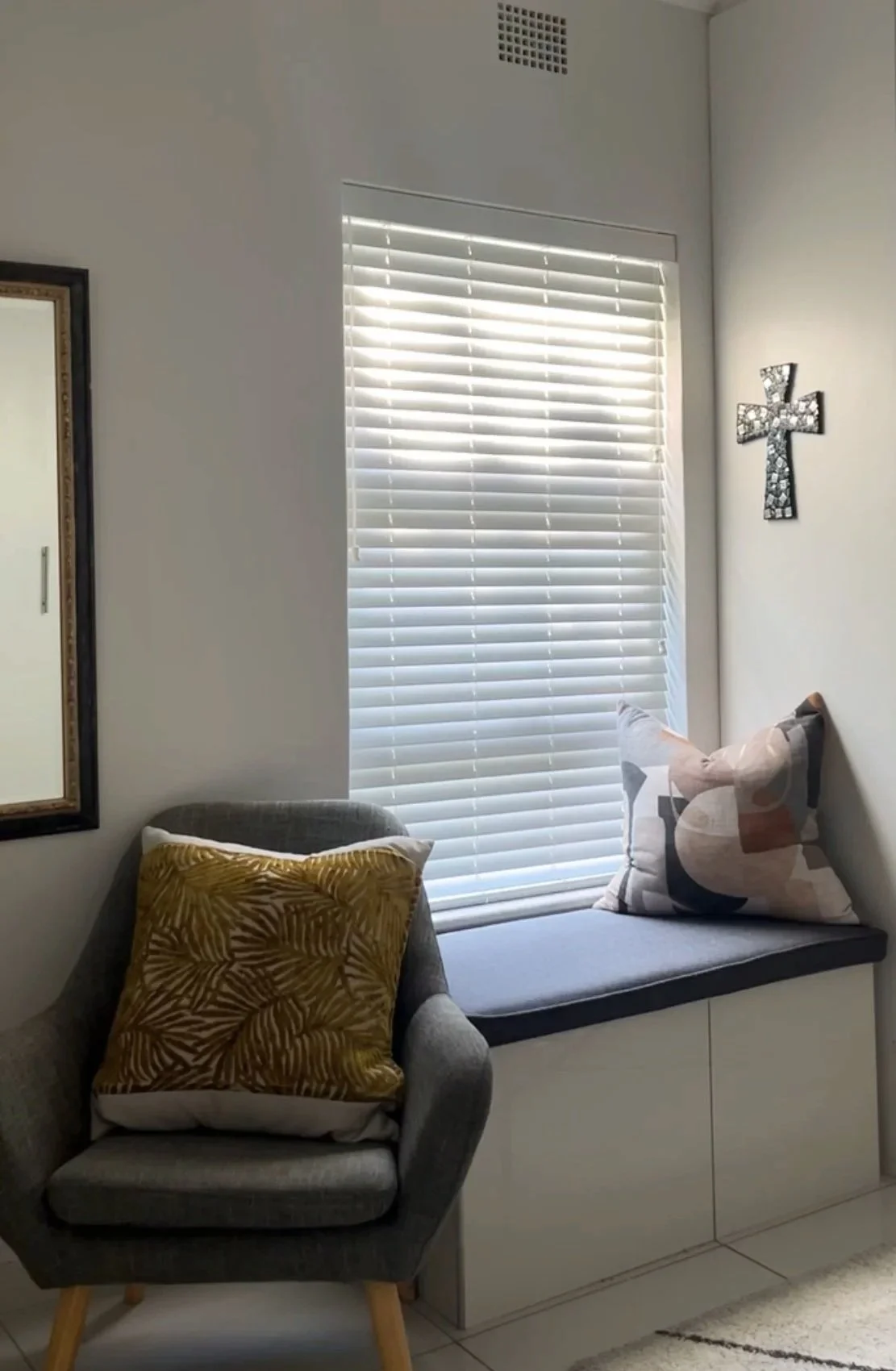 White wooden bedroom blinds are perfect for a reading nook.