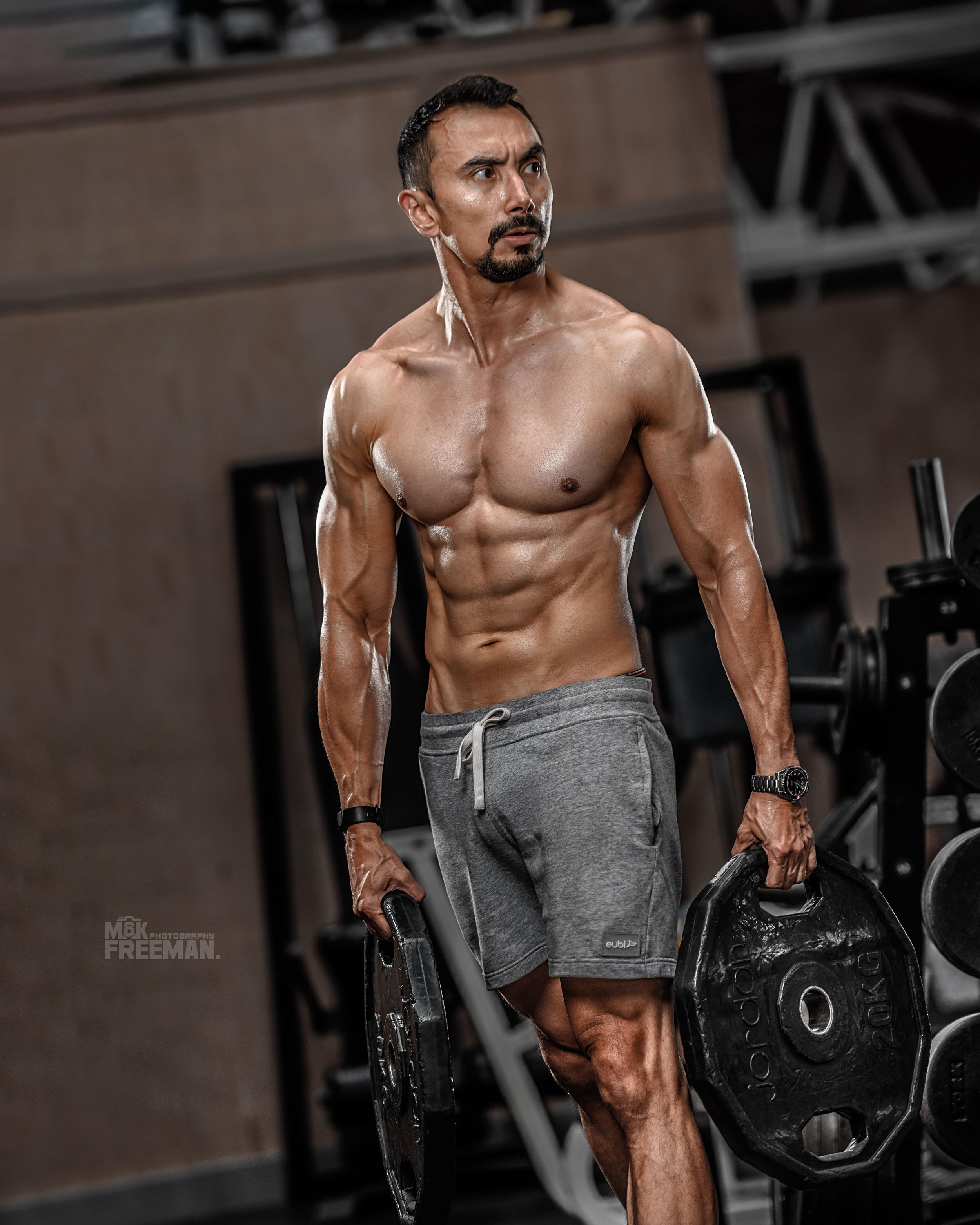 Male fitness model with naked torso posing in gym Stock Photo | Adobe Stock