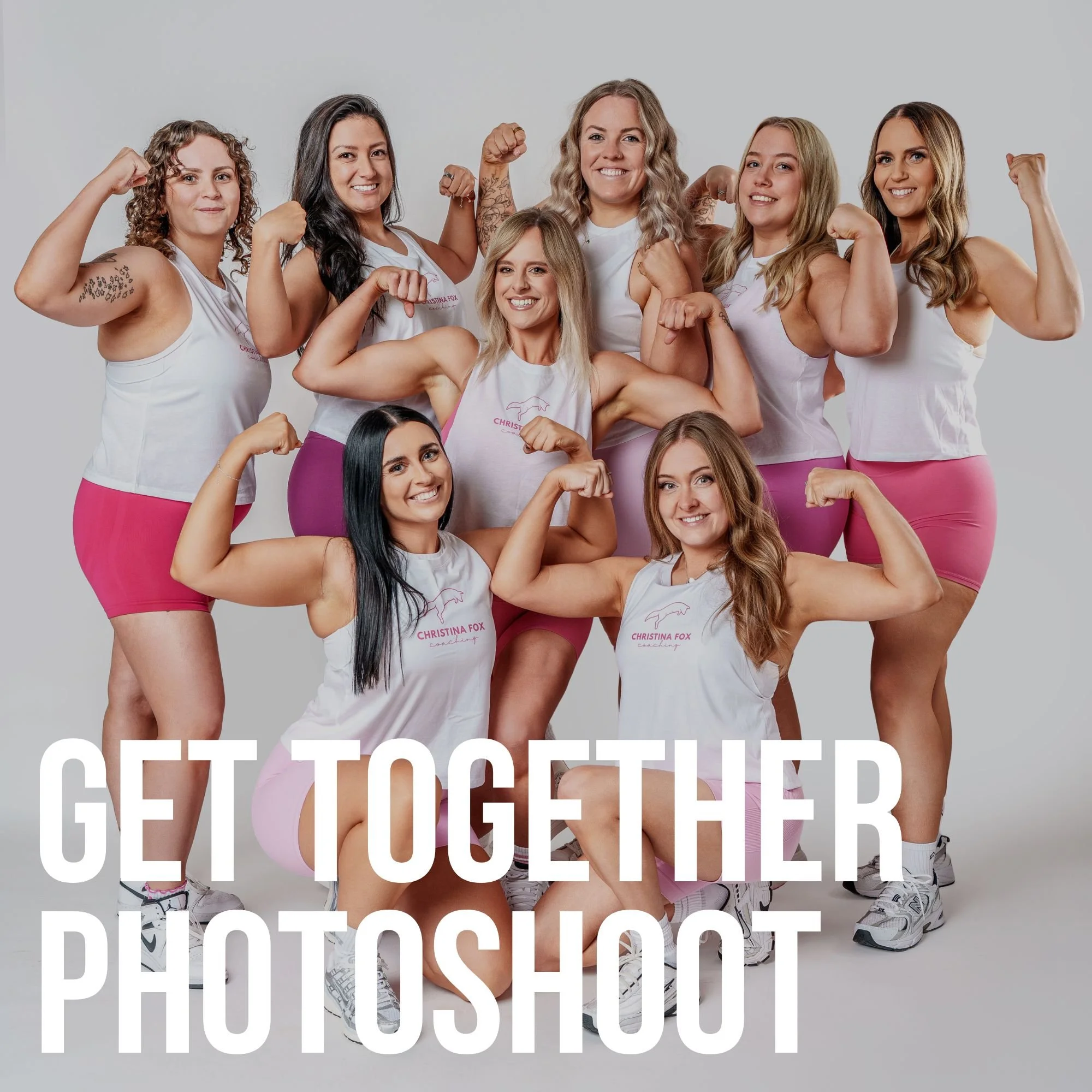 Group of eight women posing together in a studio with large industrial windows, some sitting and some standing, wearing black sports bras and shorts, with the words 'GROOP PHOTOSHOOT' overlaid.