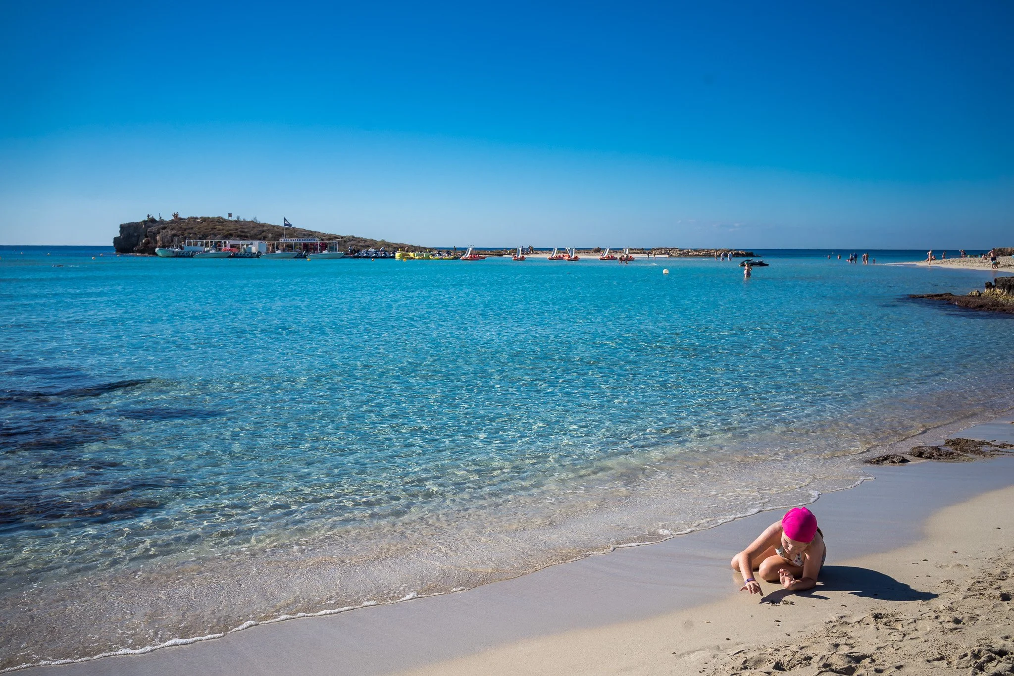 Aerial view of Nissi Beach sandbar and turquoise shallow waters at sunrise — iconic Ayia Napa must-visit spot for beach photography and drone compositions.