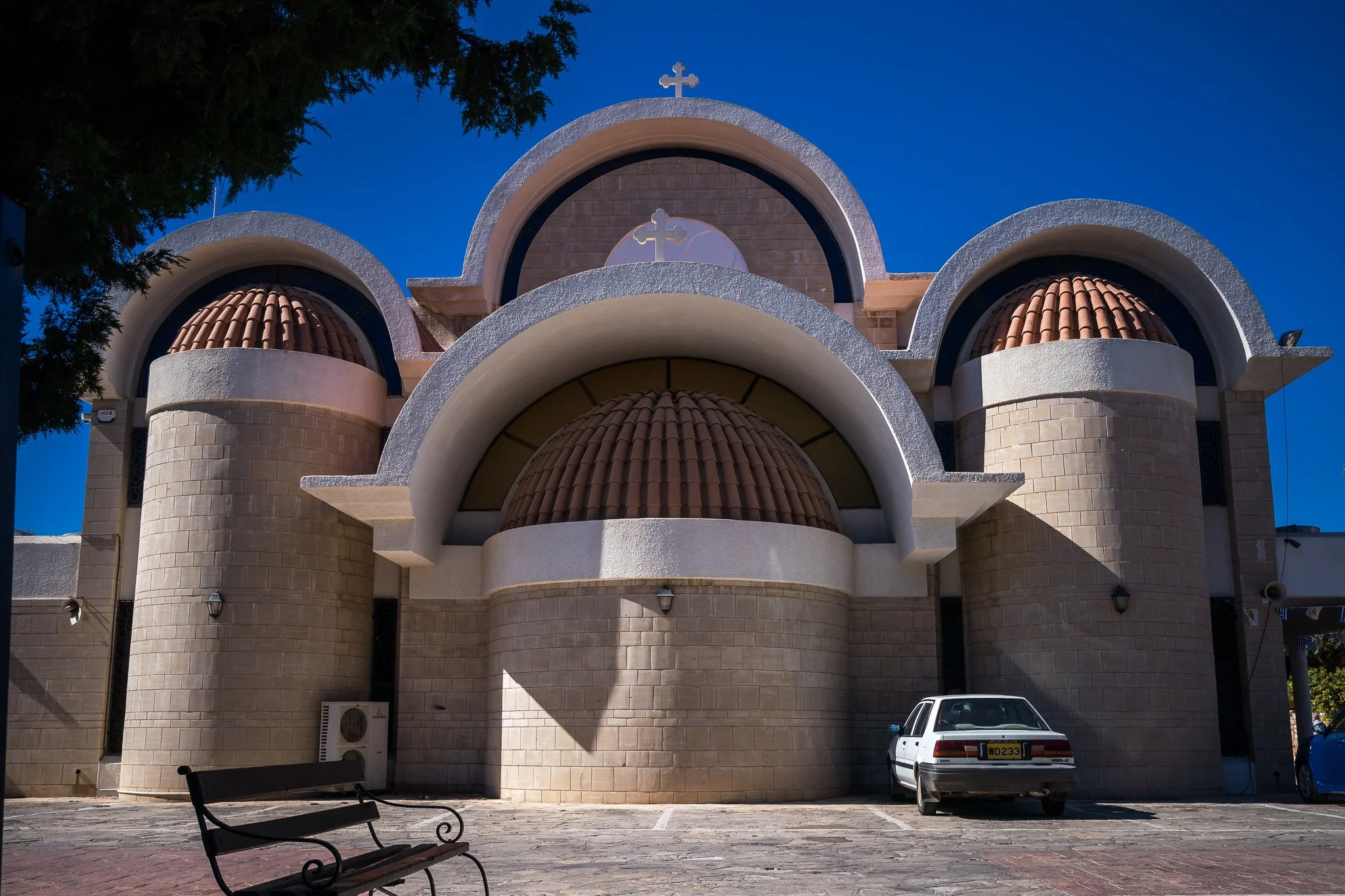 Ayia Napa Monastery courtyard with stone archways and central garden — cultural and architectural photo opportunity in Ayia Napa town center.